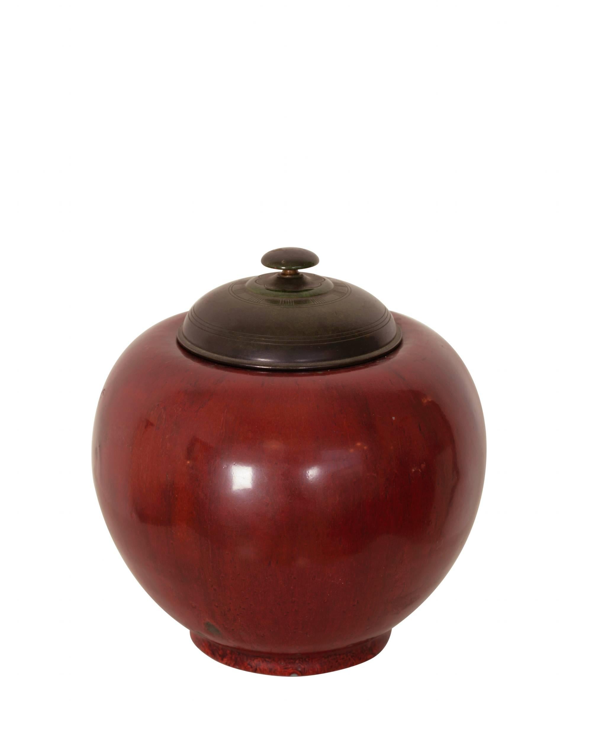 Stoneware vase with red oxblood glaze and patinated bronze lidd. 
Royal Copenhagen nr. 38/4.