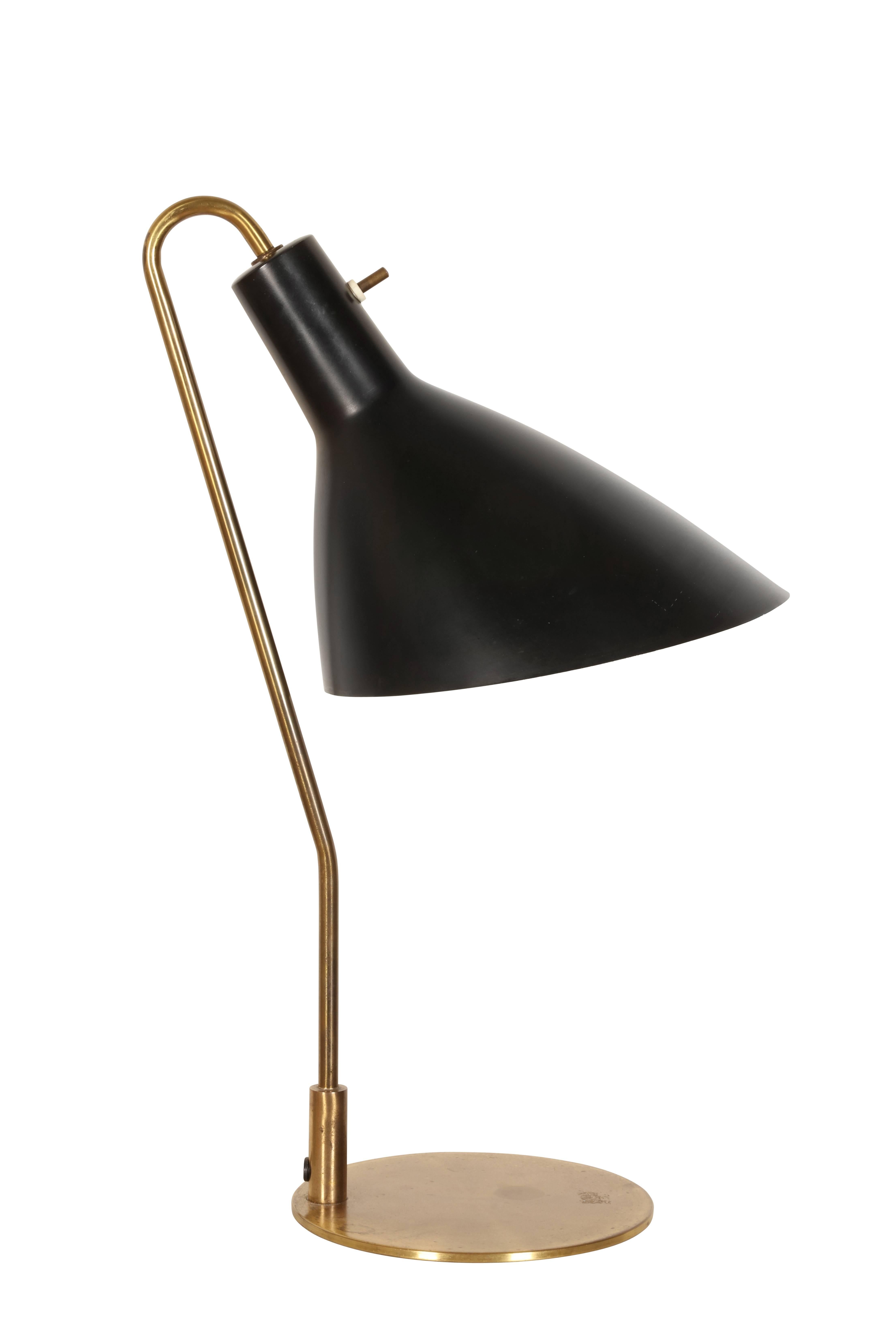 A rare table lamp in brass and original black painted metal shade.