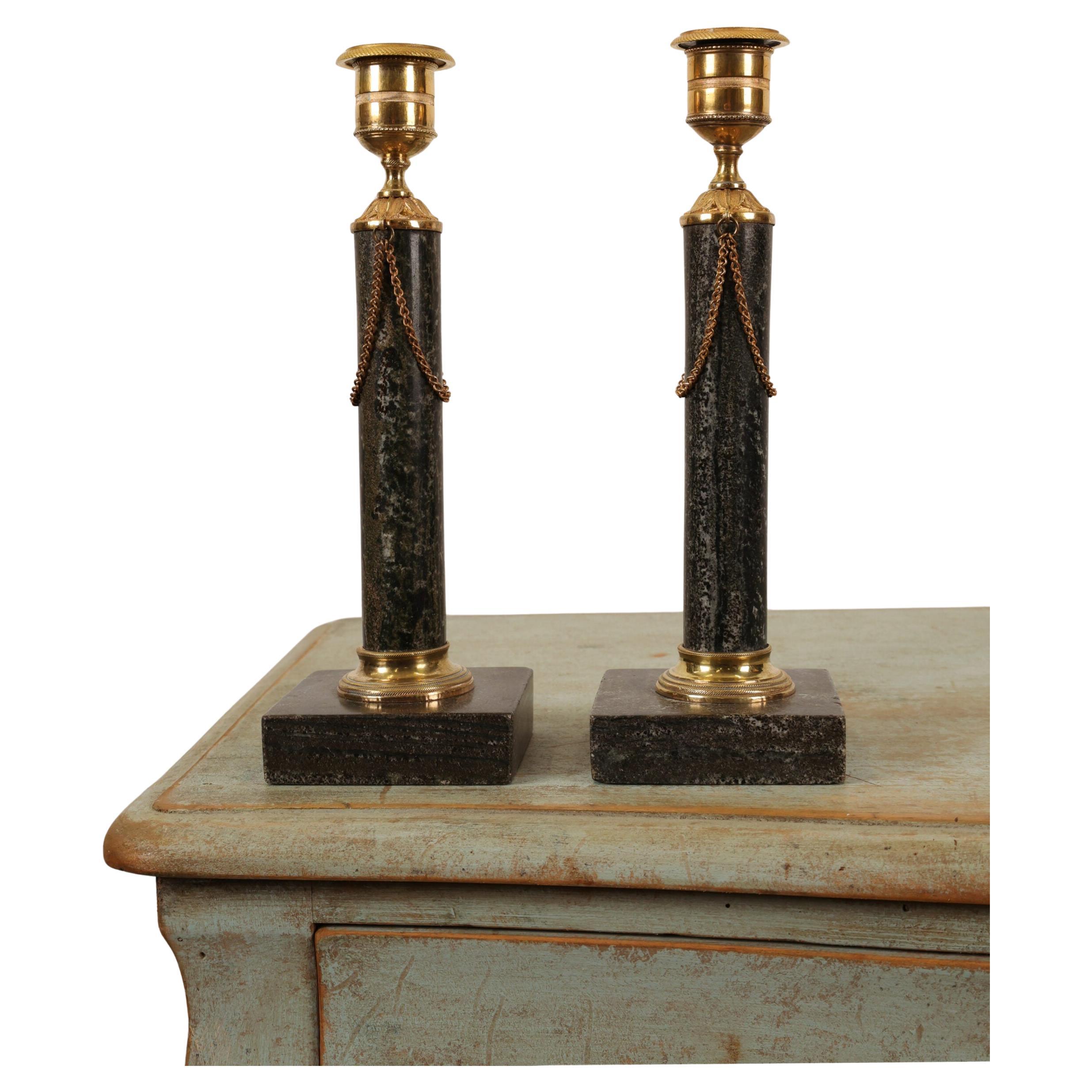 A pair of exceptionally elegant candlesticks made from Swedish green-black Kolmården marble. The candlesticks feature beautiful burnished gilt bronze mountings and chain hangings. They were most likely made in Stockholm.

Height: 24.5 cm
Base: 8x8 cm
