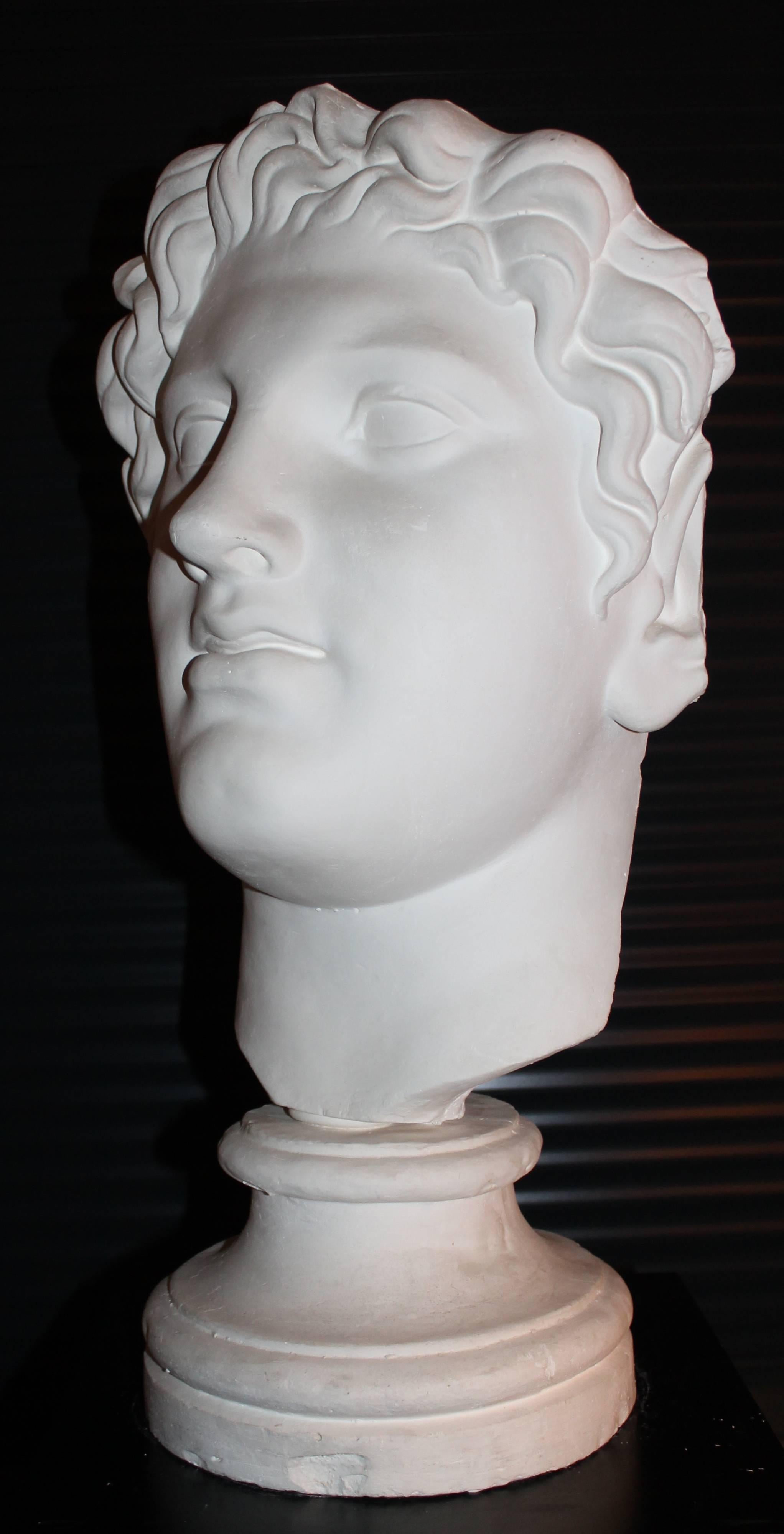 Head of a young faun on a base, in stucco, Italy, 1960s.
Signed (not readable).