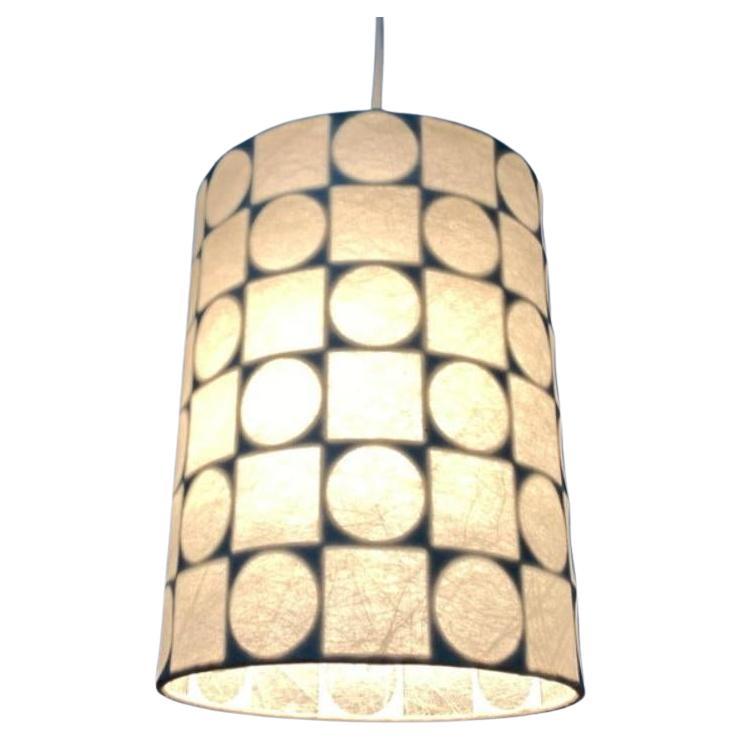 Rare mid-century cocoon pendant light from goldkant after a design by friedel wauer from the 1960s.

A minimalist design with a characteristic umbrella pattern. The lamp shows a simple cylinder shape. The actually special is the graphic pattern of