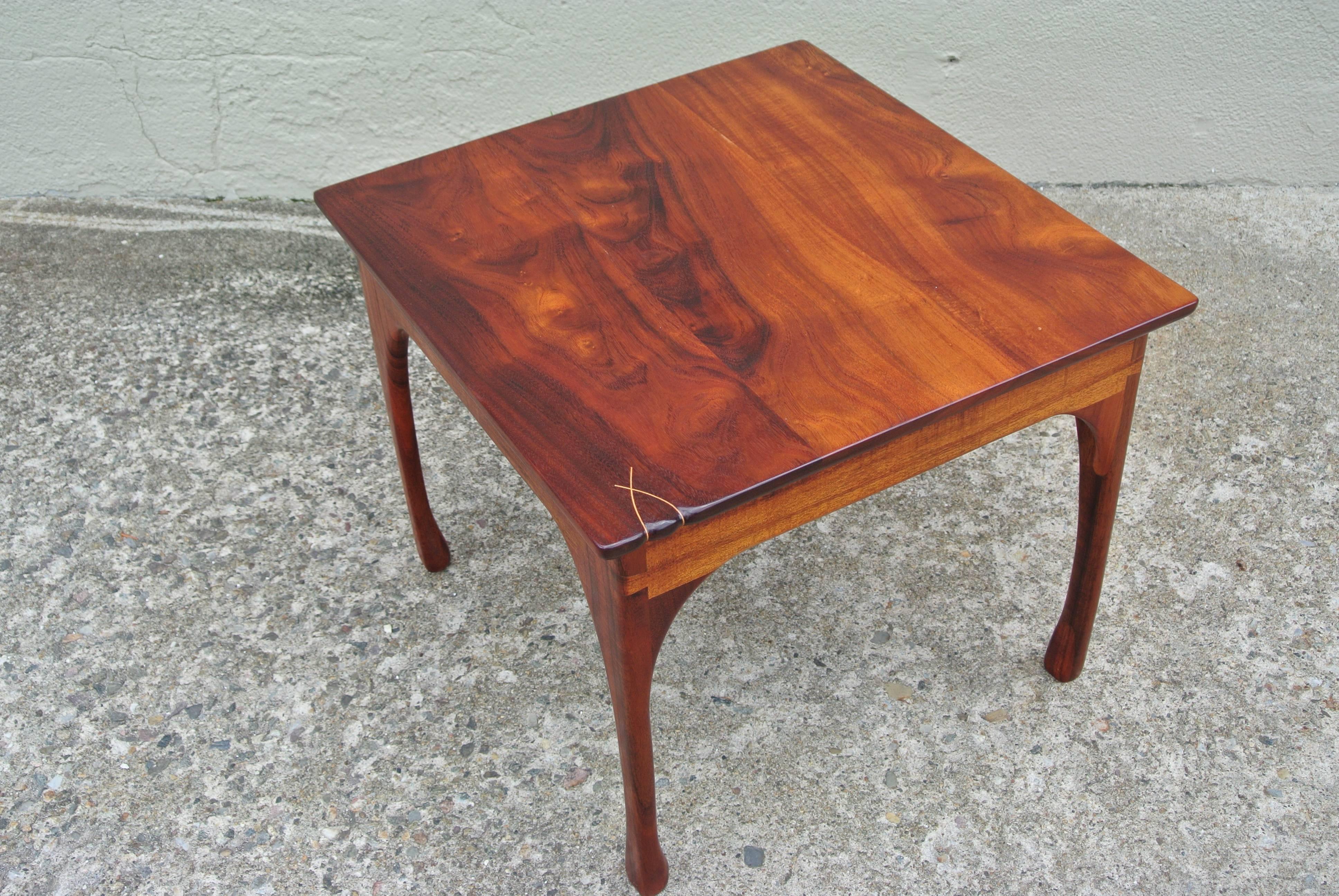 Beautiful custom Kona wood side table by Tom Deady. Sculpted brass details to the front edge and right front leg. Legs are fitted with dovetail notches.