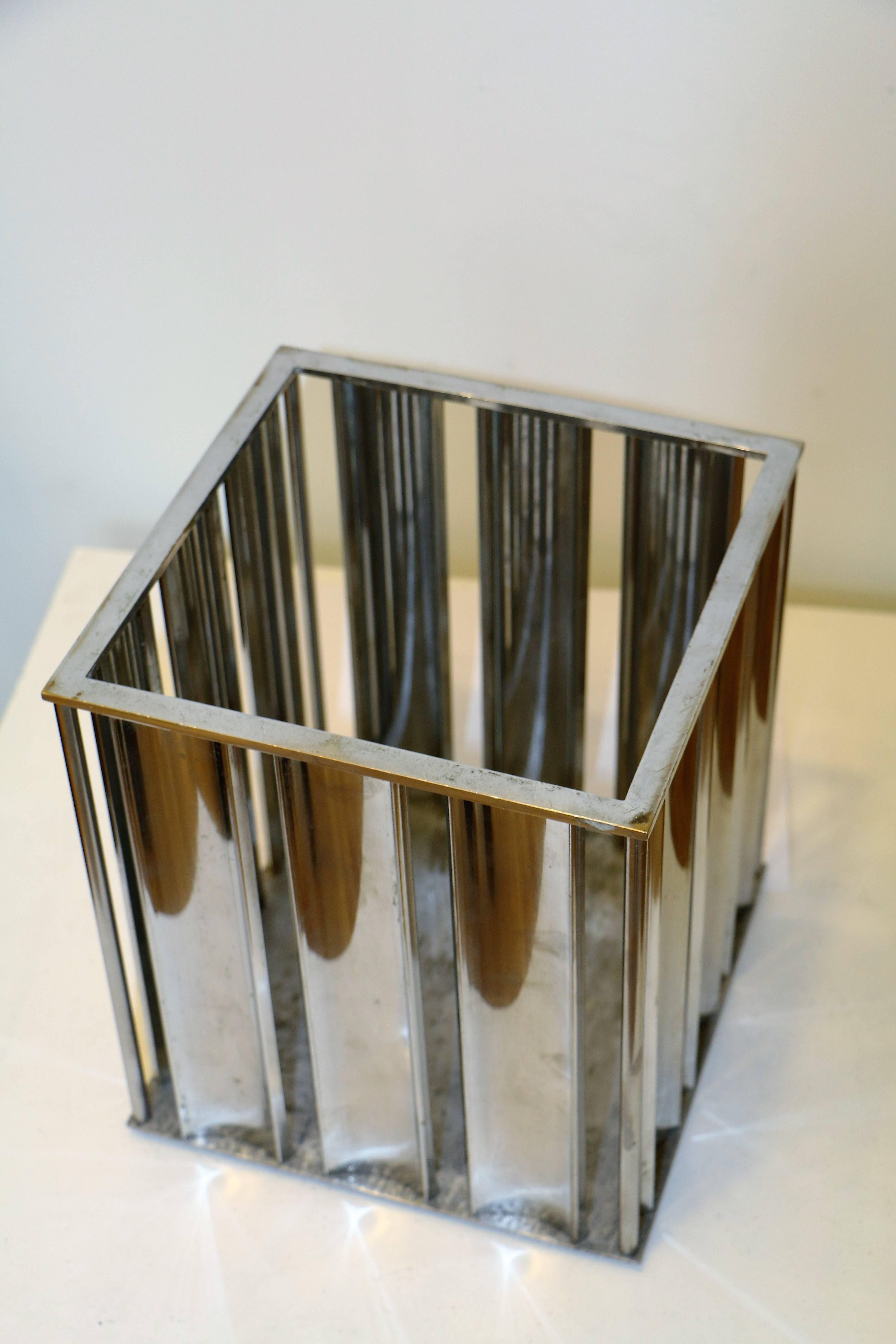 This wastepaper basket was designed by Jacques Adnet (1901-1984) circa 1930. The body is made of chromed brass plates. This is a stunning example of French modernist design by the leading Art Deco French designer.