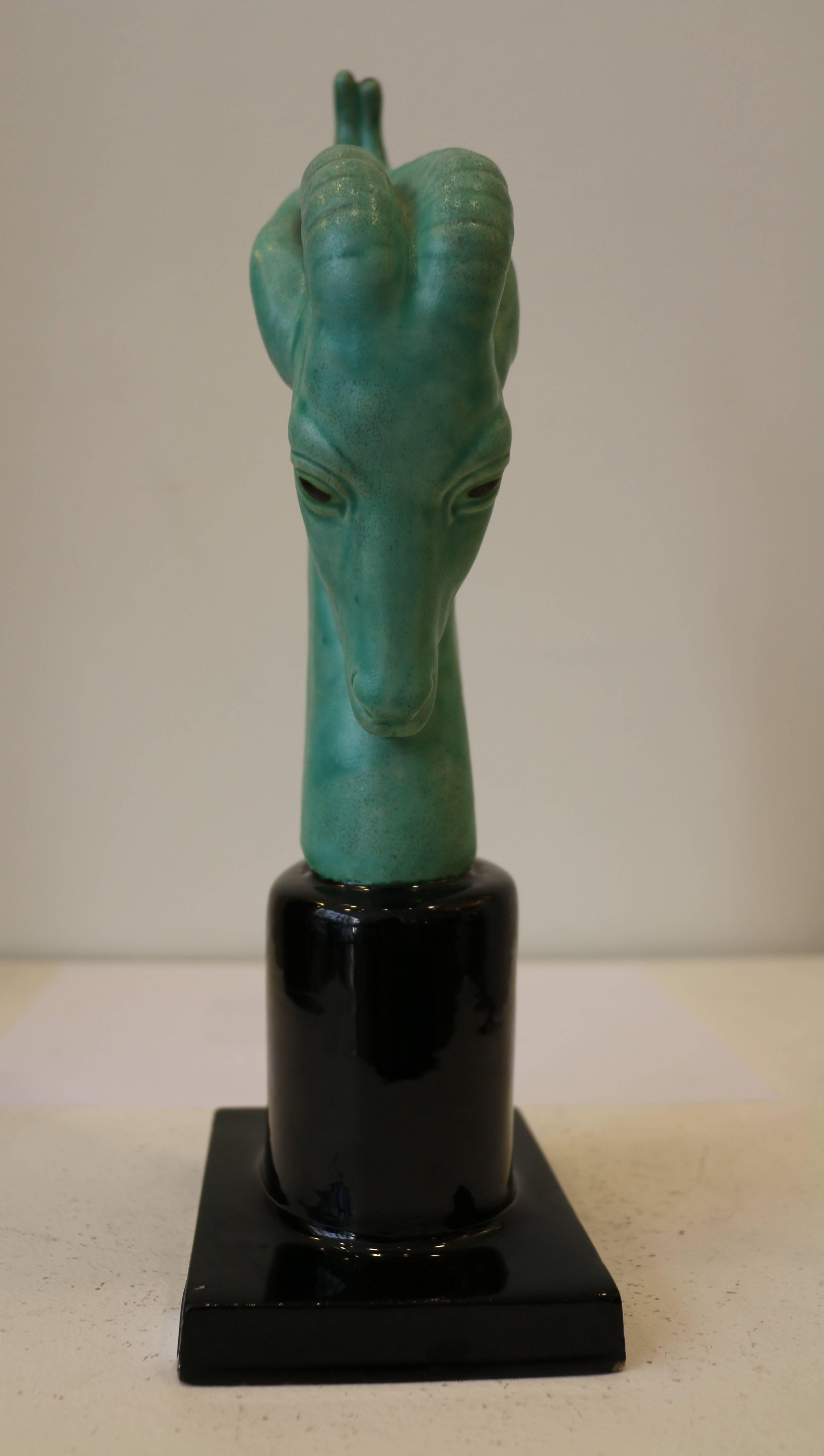 Superb and rare head of an Antilope by Paul Milet (1870-1950).
Sèvres China. 
Seagreen color for the head and black for the column shaped base.
