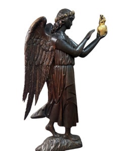 A large English oak relief carving of an angel, early 20th century