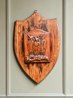 A Swiss Black Forest Linden Wood carving of a Parliament of Owls set on a shield
