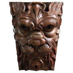 An English carved oak lion mask panel, 19th century, in the 17th-century manner