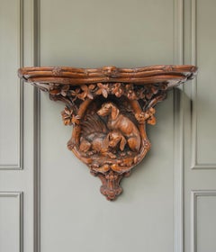 A Black Forest Carved Linden Wood Canine Wall Bracket Swiss, Late 19th Century