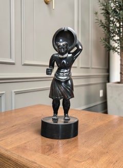 An unusual Anglo-Indian carved ebony night watch stand