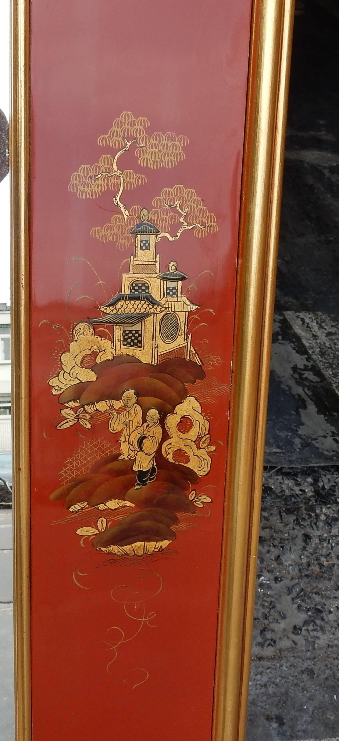 Mirror decorated with lacquer panels of red and gold China in a gilt frame has gold leaf, good condition