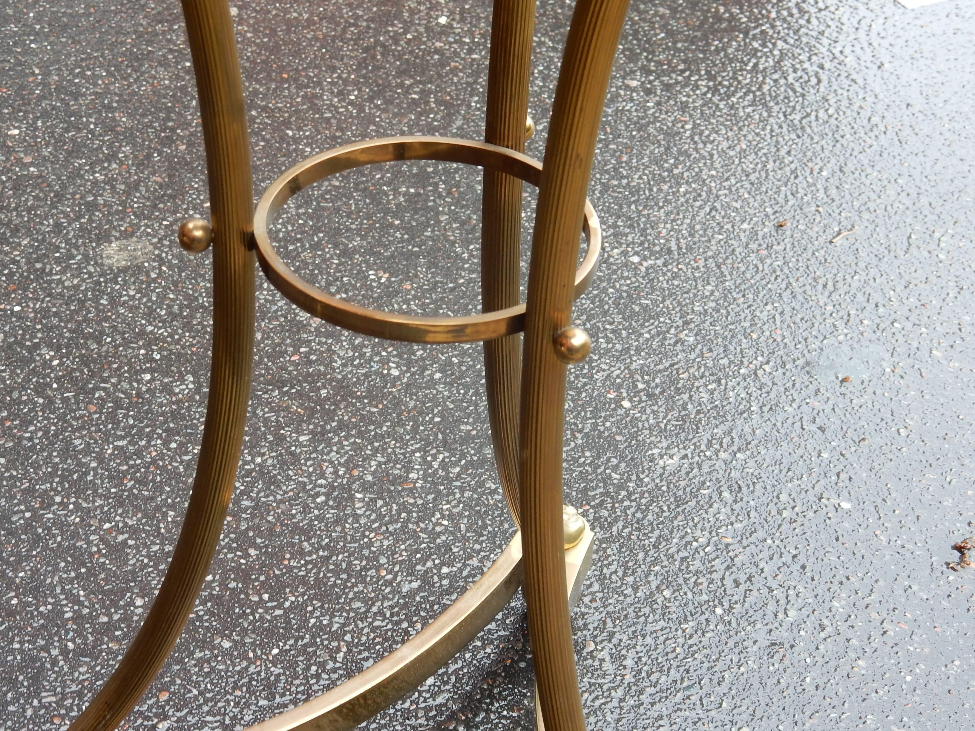 Pair of tripod pedestal table gilded bronze with loops at the end of the uprights, spacer, legs ending in claw feet ,top in 
circa 1950-1970. All is screw. Good condition.
Coming from a Parisian palace.gilted oxyded mirror