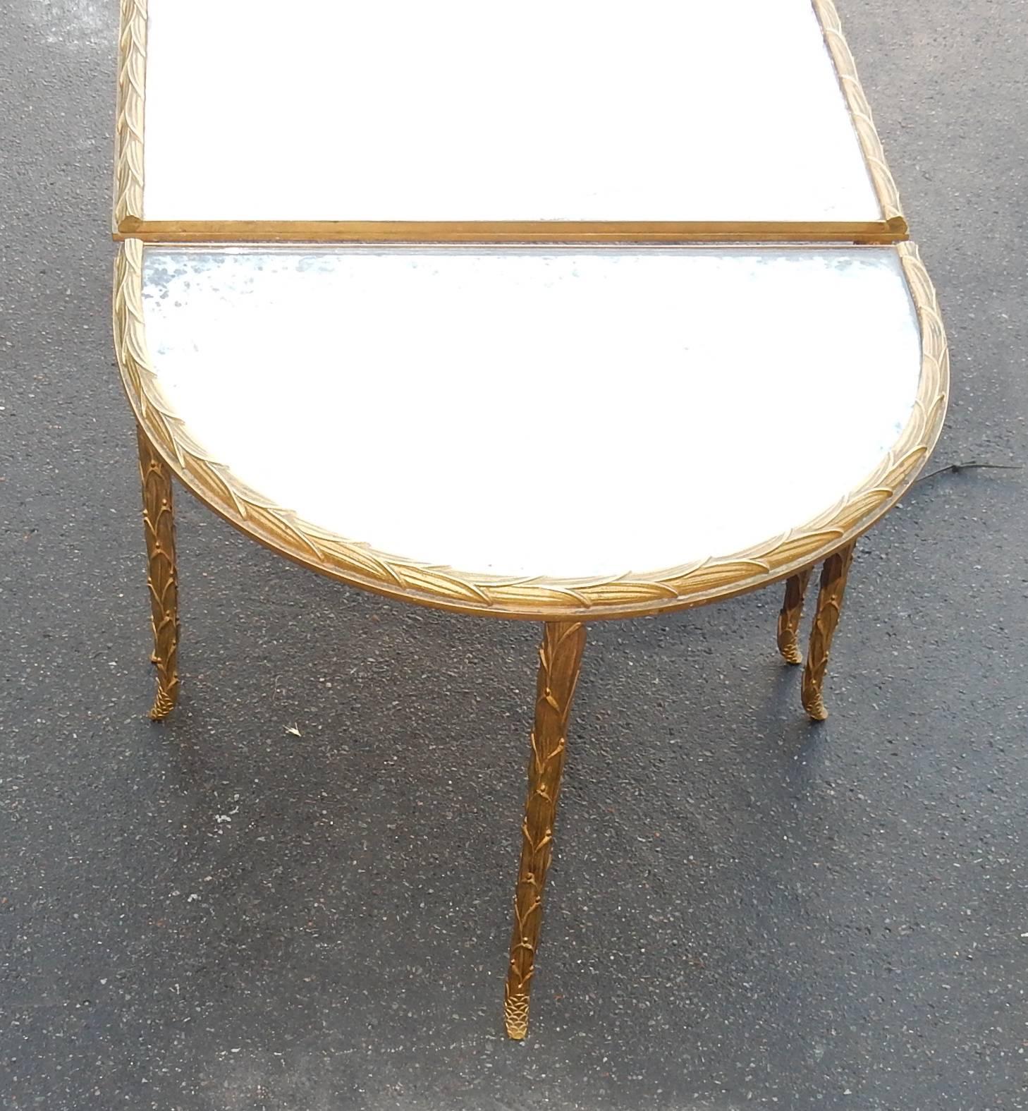 Coffee table in three parts with bronze structure and iron and brass, top in oxyded and silvered mirors, central part 61 X 49 cm and 2 ends in 1/2 moon 61 X 31, circa 1950-1970, good condition of use, every parts are screw and the belt, amounts