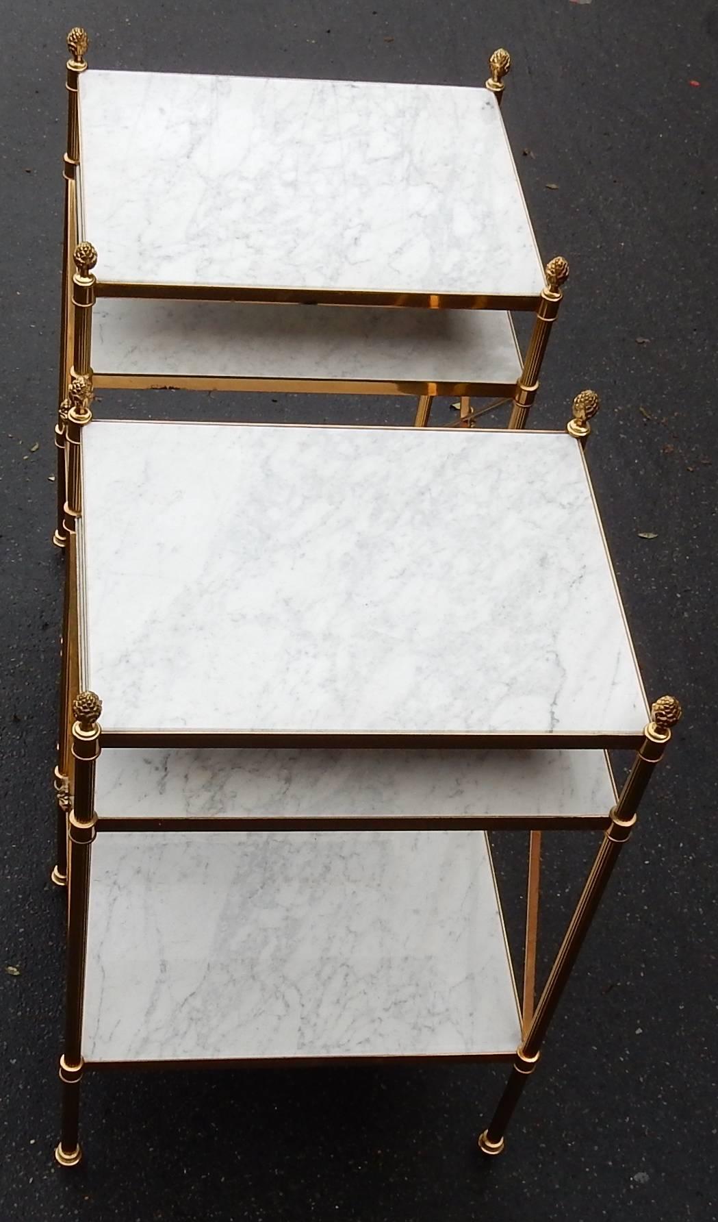 Pair of shelves with three levels with white marble, amount bronze and brass and pine cone, cross brace on the sides, circa 1950-1970, good condition.