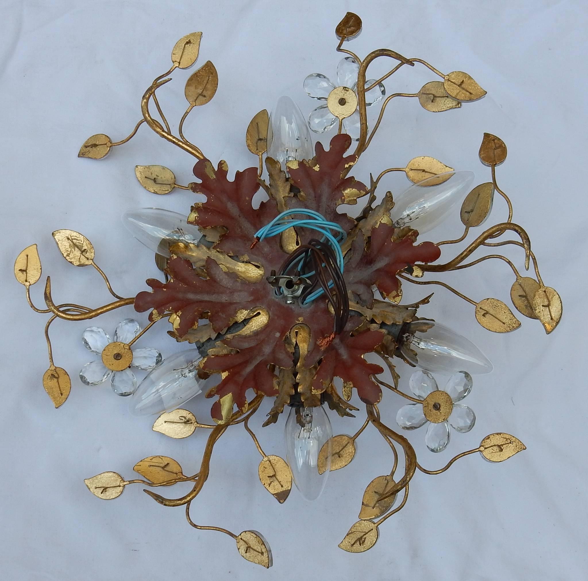 Pair of golden metal ceiling light which can be used in wall lamp, six bulbs, flowers and glass or crystal leaves, circa 1950-1970
Good condition.