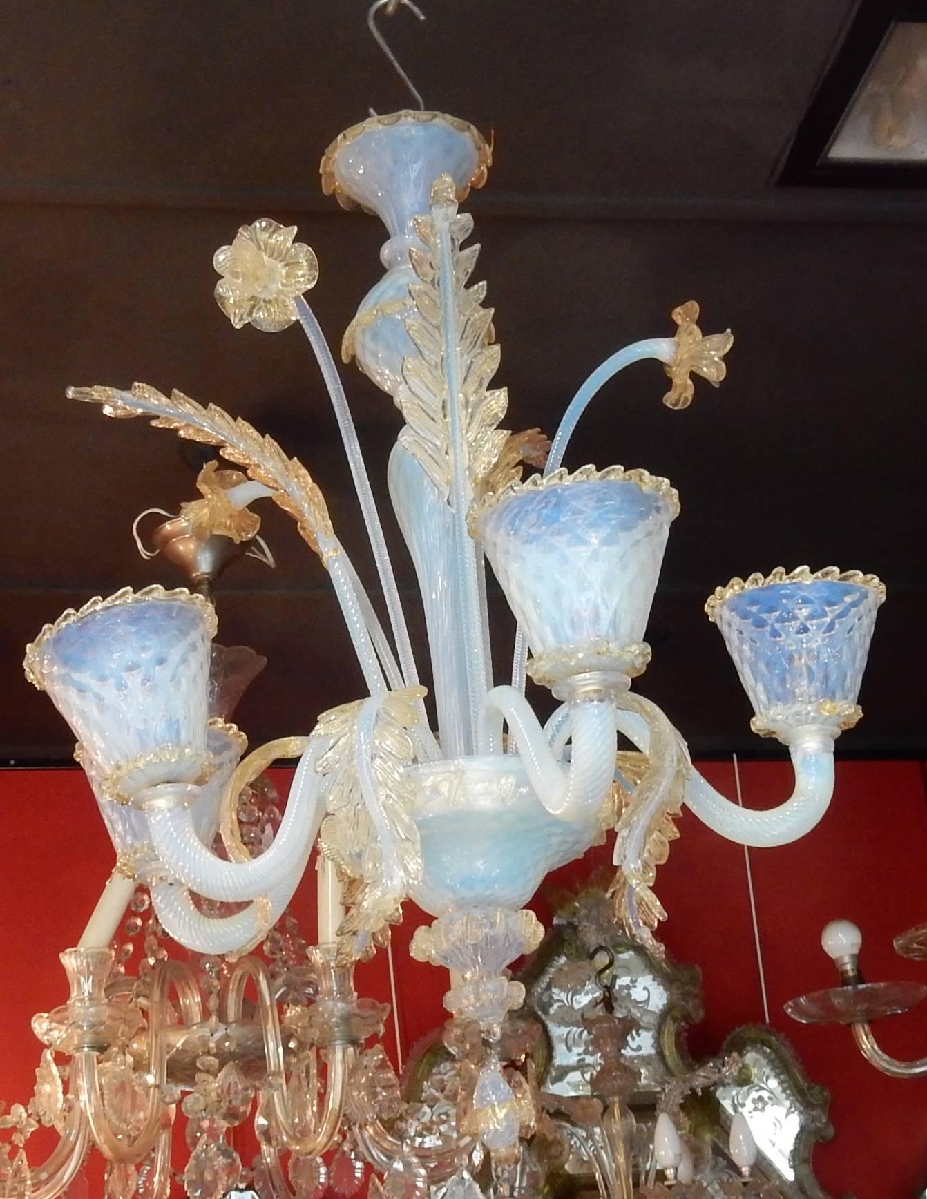 crystal blue opalescent chandelier with gold inside, three leaves up, five leaves falling, three flowers, good condition, circa 1950.