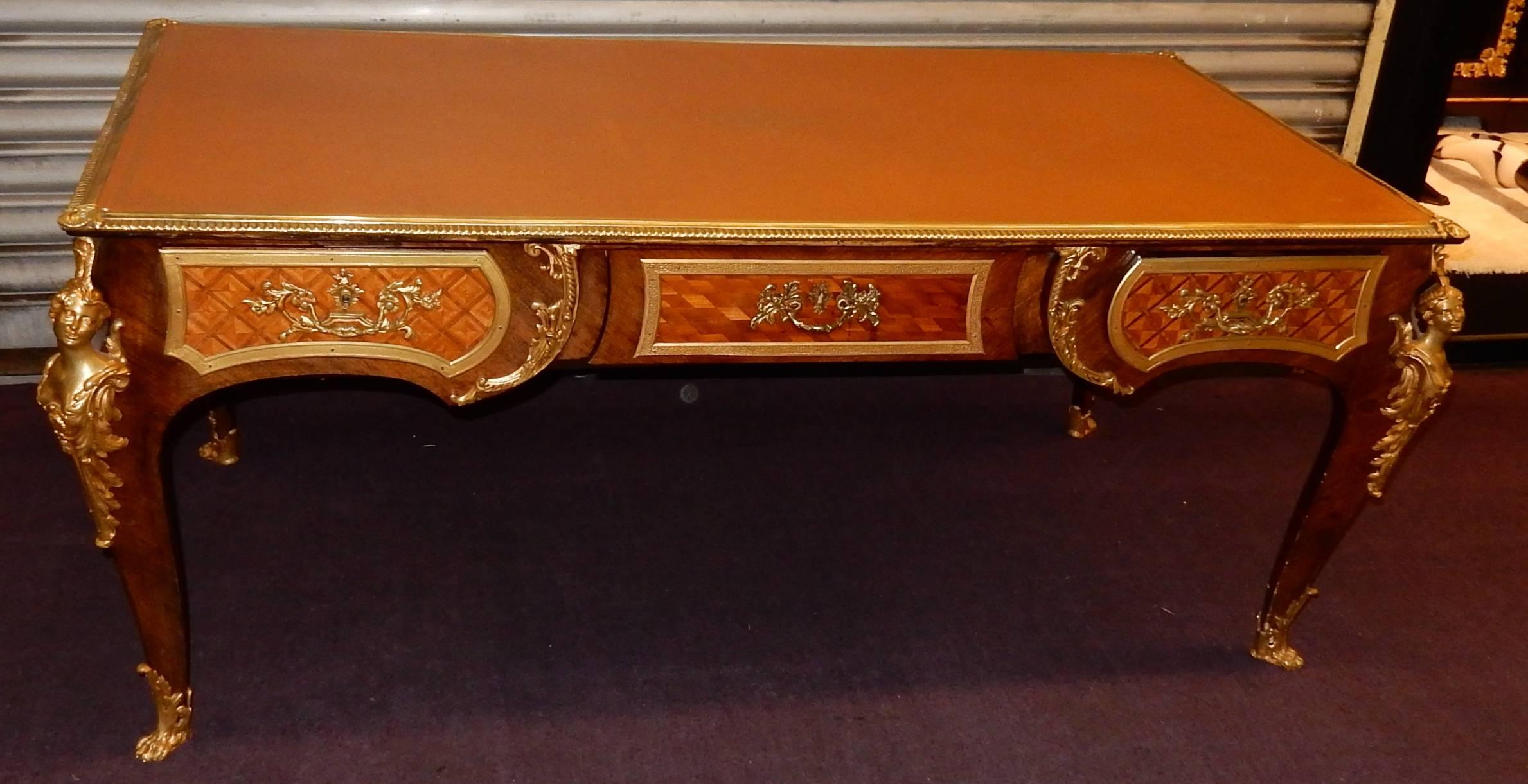 Flat Napoleon III desk has women's decoration, has l espagnolette, gone up on oak, assemblies swallow, covered with rosewood, rosewood has tails d, has decoration of checkerboard, tray decorated with bronze shells and sheathed by decorated fawn