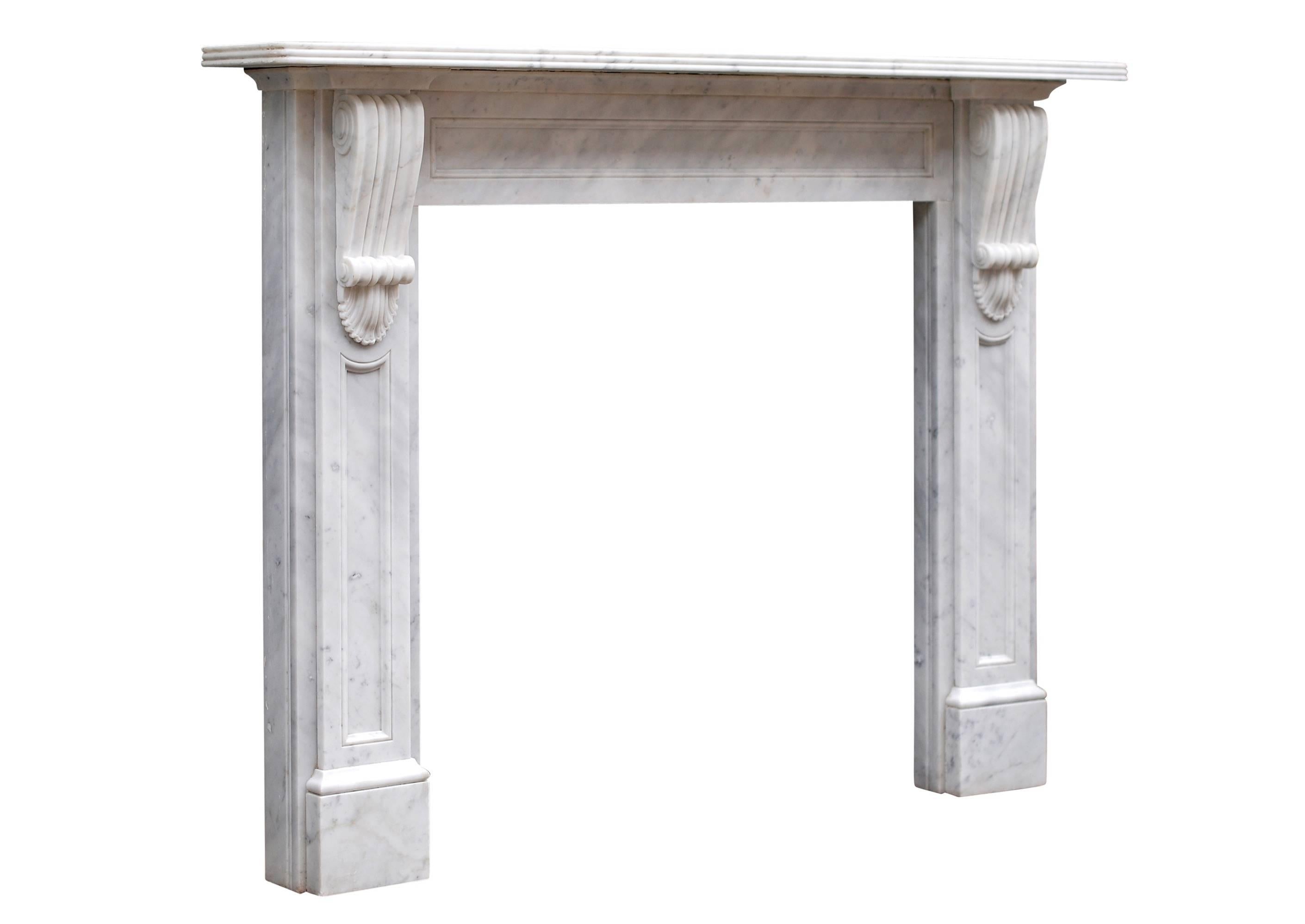 A reproduction of a Victorian fireplace in white marble. The frieze with finely carved corbels, fielded panels and a reeded mantel shelf.

Measures: Shelf width 1651 mm 65 in
Overall height 1257 mm 49 ½ in
Opening height 1016 mm 40 in
Opening