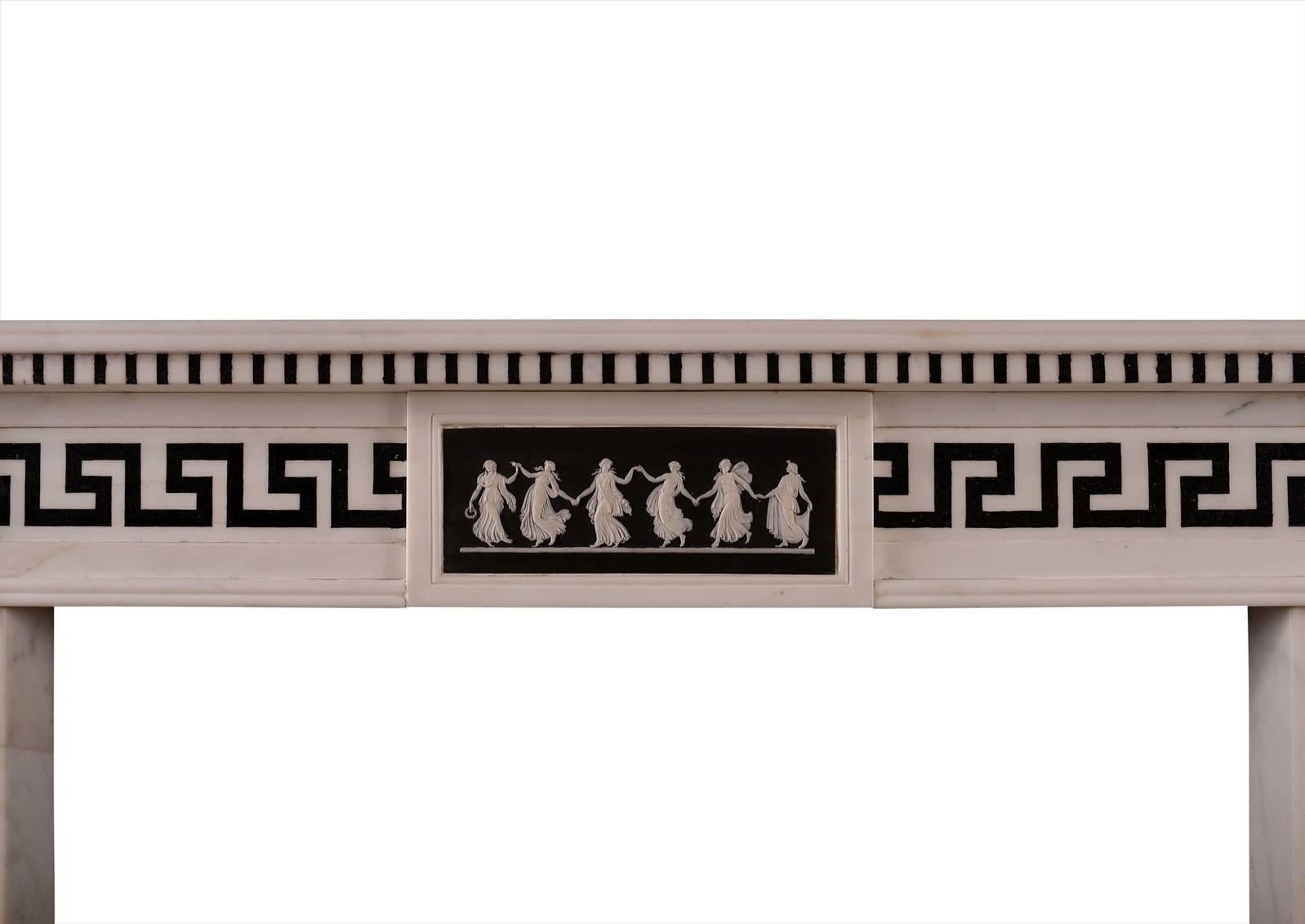 A Regency style white marble fireplace. The jambs and frieze with black Greek key inlay, the frieze with carved paterae to end blocks and finely cast composite centre featuring dancing ladies. Moulded shelf above, English, early 20th