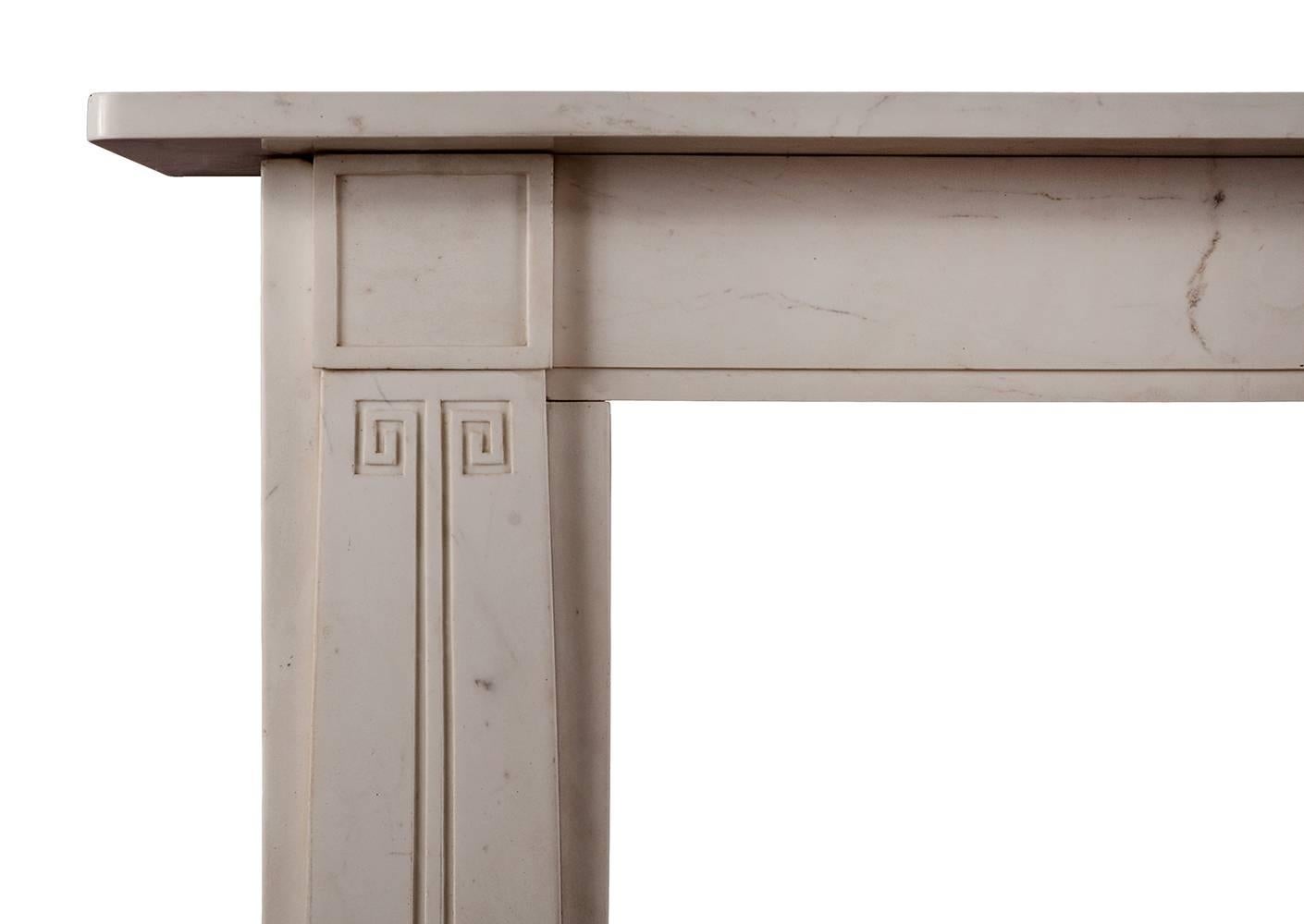 A refined Statuary marble fireplace in the manner of Sir John Soane. The tapering jambs with Greek key decoration, surmounted by square panelled blockings. Plain frieze and shelf, English, early 19th century. Photo taken prior to