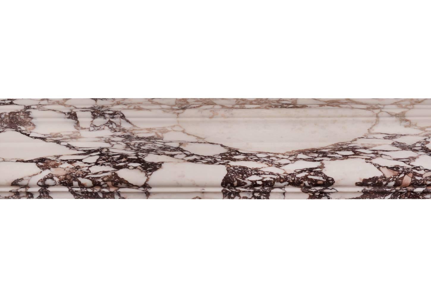 A fine quality English moulded bolection in Breche Violette marble. Moulded frieze and jambs. Modern production from an old block of marble. English.

Shelf Width - 1435 mm    56 ½ in
Overall Height - 1105 mm    43 ½ in
Opening Height - 937 mm  