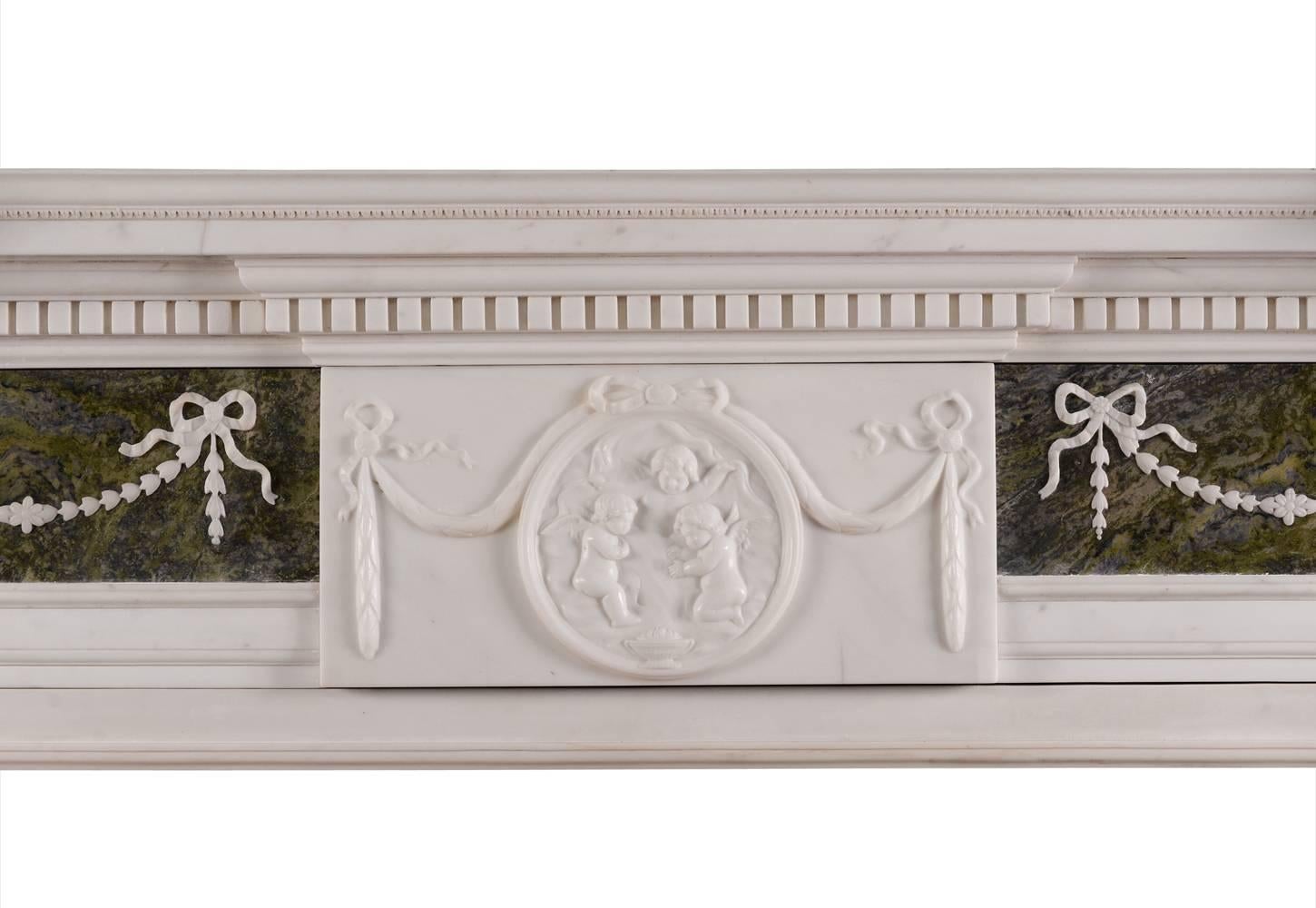 A fine quality George II English marble fireplace in statuary and connemara marble. The jambs with connemara green marble columns surmounted by delicately carved stiff acanthus leaves and ionic capitals. The frieze with statuary marble centre plaque