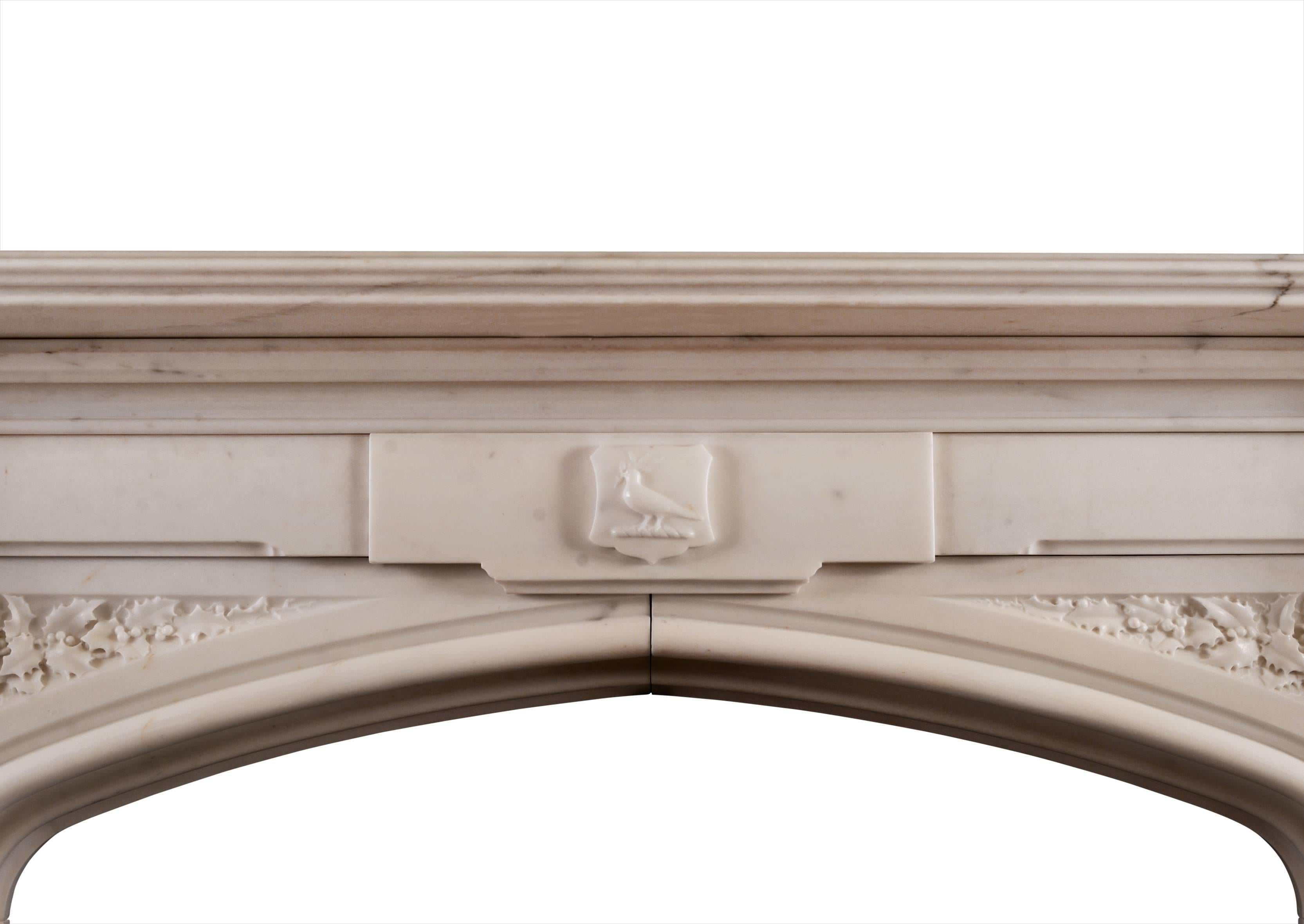 A fine quality Gothic Revival fireplace carved in statuary marble. The spandrels with finely carved holly and berries. Octagonal suspended capitals under moulded shelf. The centre with small carved dove holding an olive branch. Very good quality