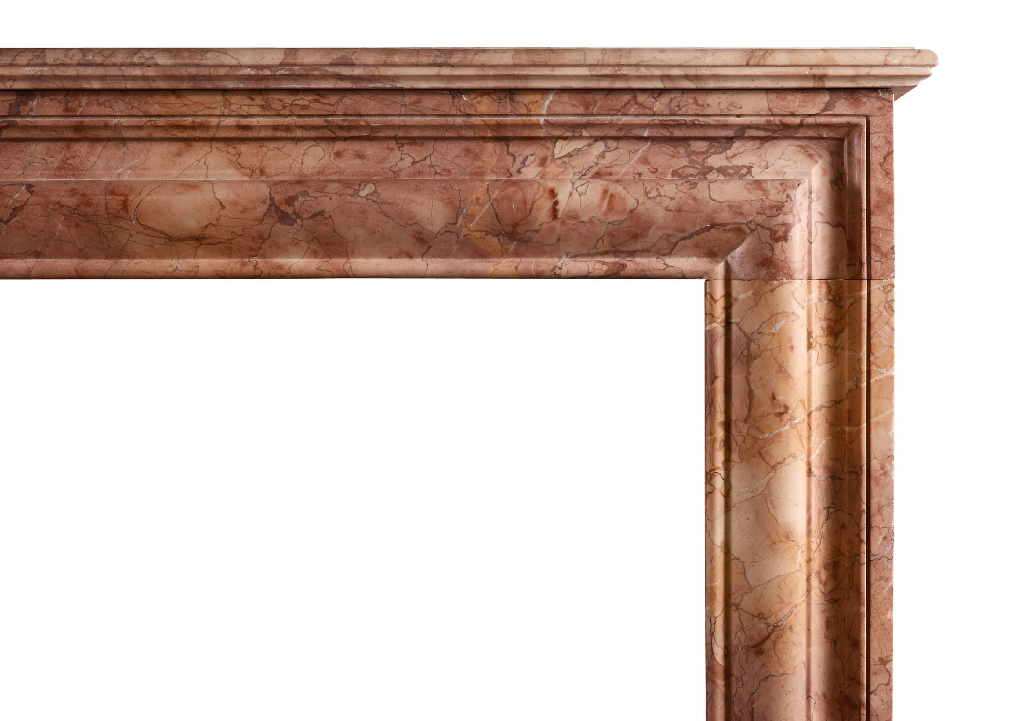 A Napoleon III fireplace of architectural form in Rosso Verona marble. The frieze and jambs with bolection detail and plain returns. Mould shelf above. French, late 19th century.

Shelf width - 1676 mm 66 in.
Overall height - 1140 mm 44 ⅞