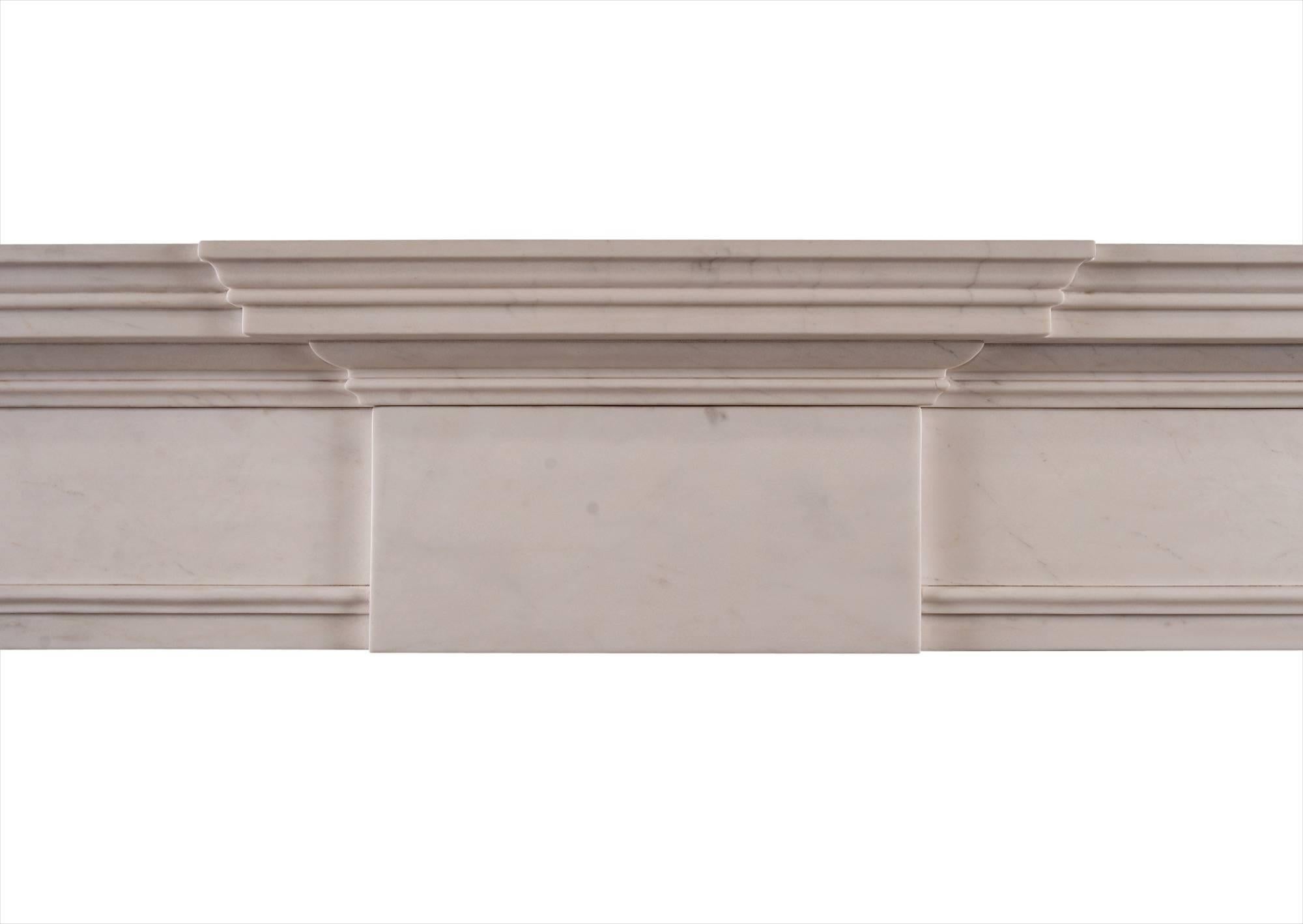 An English Georgian style fireplace. The plain jambs surmounted by scotia moulding and plain end blocks. The frieze with plain centre panel with moulded shelf above. An attractively simple model in the classical style. Modern.

Measure: Shelf width
