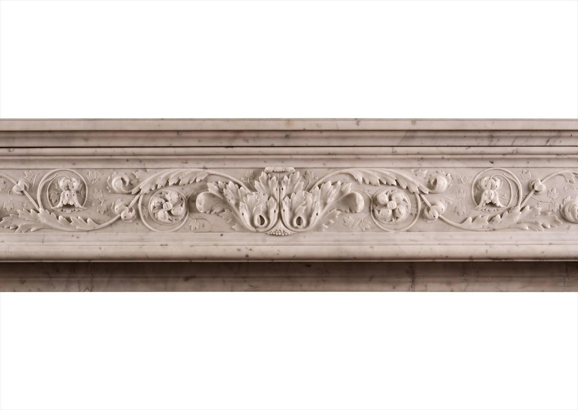 A fine quality Louis XVI style fireplace in Italian Carrara marble. The shaped jambs with carved acanthus leaves and scrollwork, surmounted by carved square paterae. The shaped, frieze with foliage, bellflowers and fine leaf work throughout. Paneled