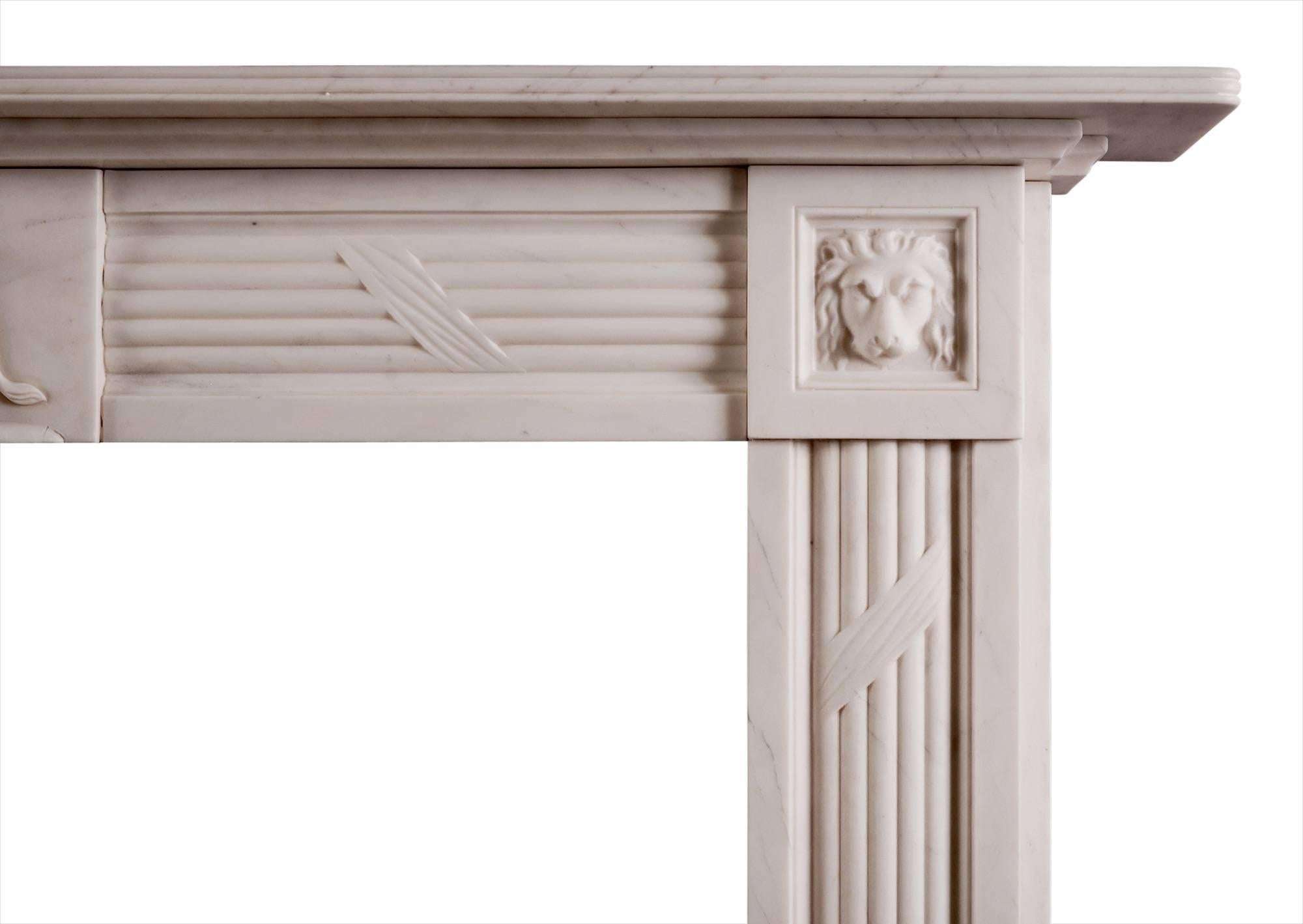 A Regency style white marble fireplace with reeded and ribboned frieze and jambs. The carved centre panel depicting a scene of Androcles and the lion, with associated lions heads to side blockings. Reeded shelf. A copy of an early 19th century