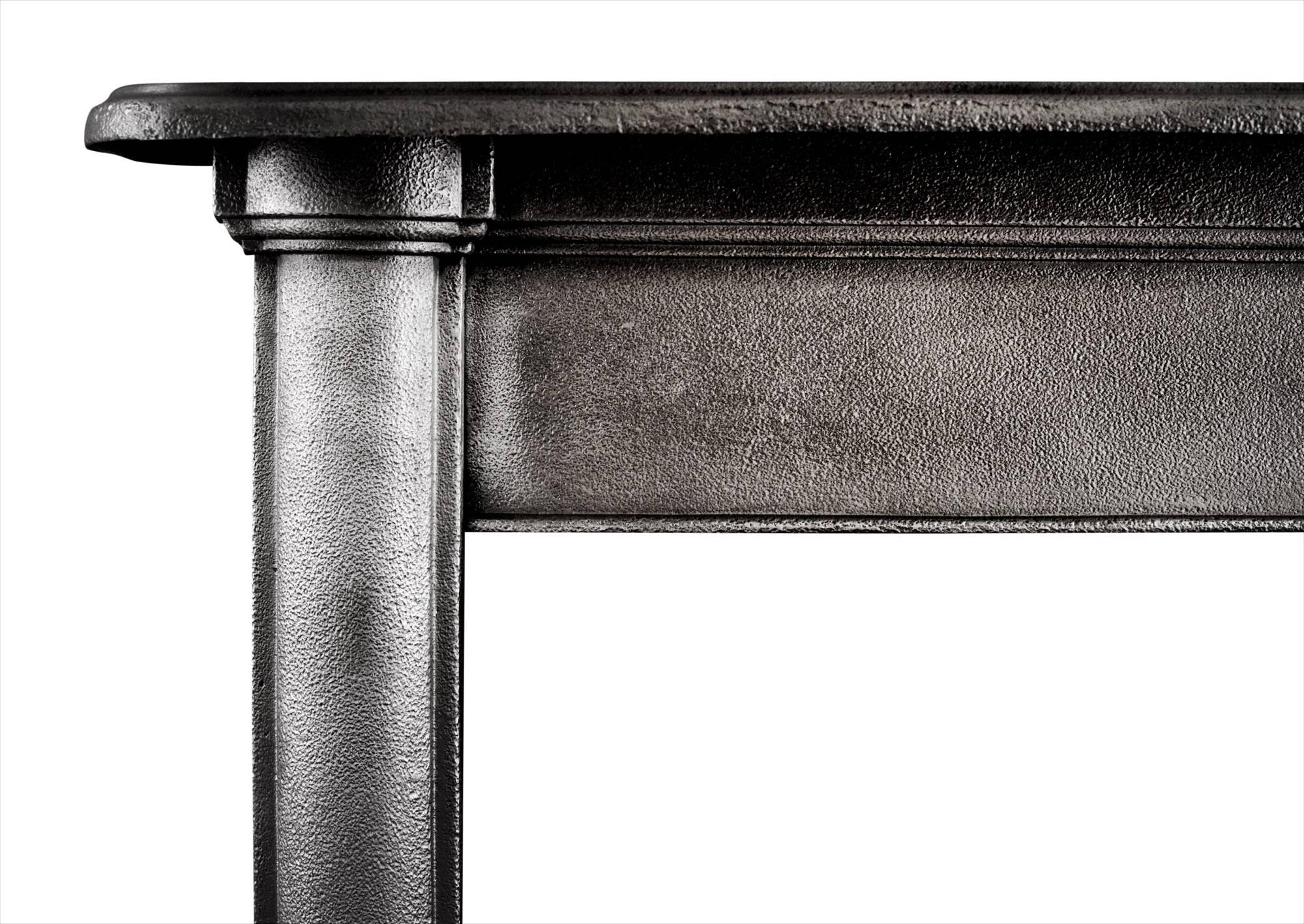 A simple, yet elegant polished cast iron fireplace. The half rounded pilasters surmounted by plain frieze and molded shelf, English, circa 1900.

Measures: 
Shelf width - 1300 mm / 51 1/8 in
Overall height - 1175 mm / 46 1/4 in
Opening height - 955