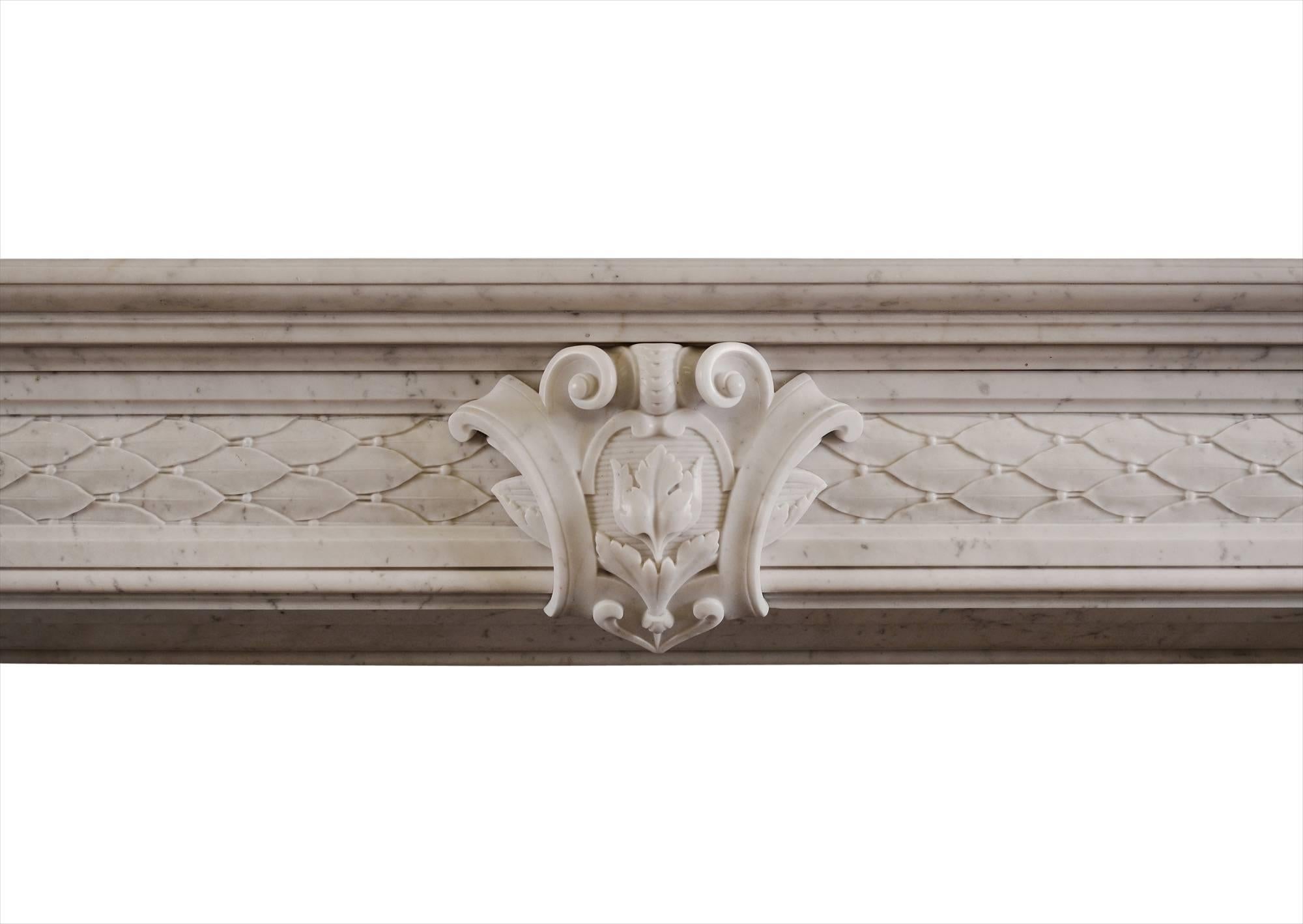 A 19th century white marble fireplace. The jambs and frieze with carved leafwork and berries throughout and carved cartouche to centre. Moulded shelf above.

Measurements:
Shelf width - 1735 mm / 68 1/4 in.
Overall height - 1195 mm / 47 in.
Opening