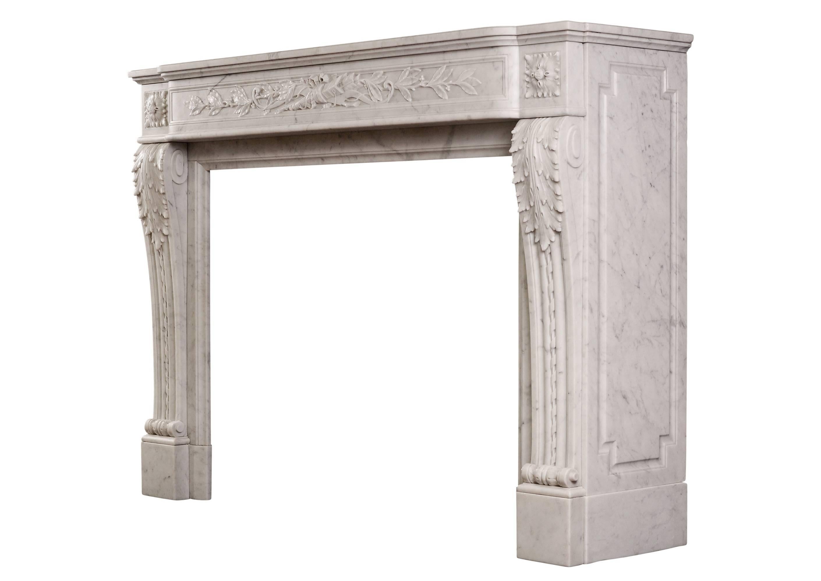A mid-19th century French Louis XVI style Carrara marble fireplace, with panelled frieze delicately carved with quiver, arrow and foliage. The shaped jambs with acanthus leaves, rope moulding and square paterae above. Moulded