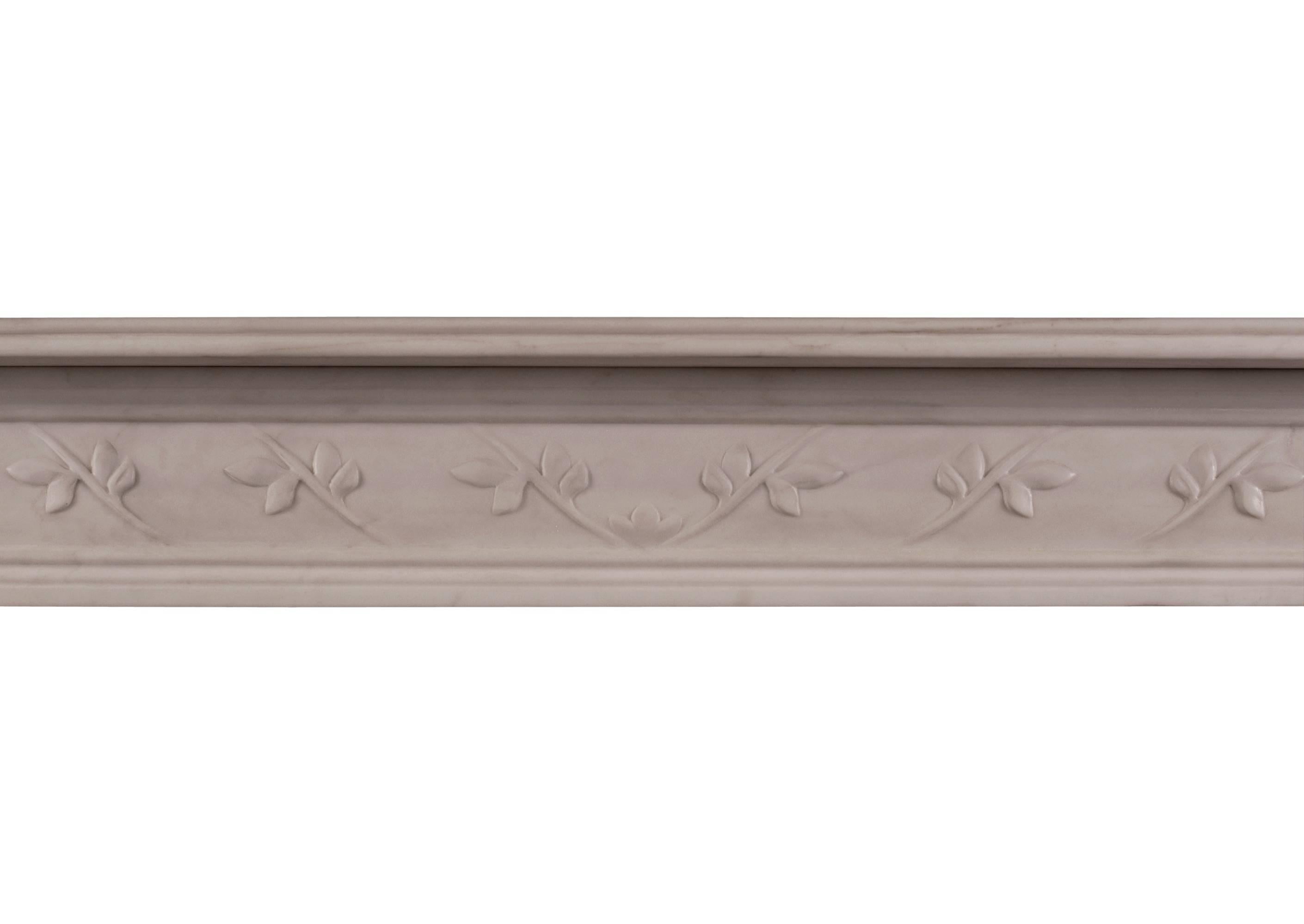 A delicate English Regency white marble fireplace. The reeded frieze and jambs with carved floral motif to centre. Round paterae of floral design to end blockings. Reeded shelf. A quality copy of an original piece.

Shelf width - 1425 mm / 56 1/8