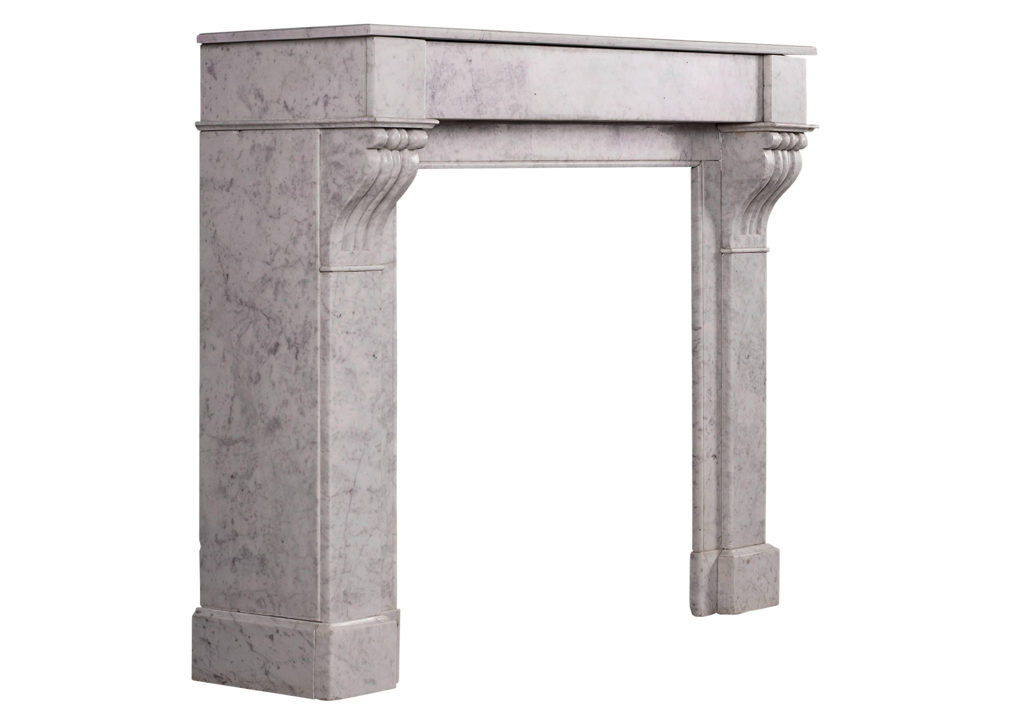 A petite French, Louis Philippe Carrara marble fireplace. The jambs with scrolled brackets to top, surmounted by plain frieze and moulded shelf. Early/mid-19th century. Well suited for a bedroom or smaller study.

Measures:
Shelf Width:	1110 mm     