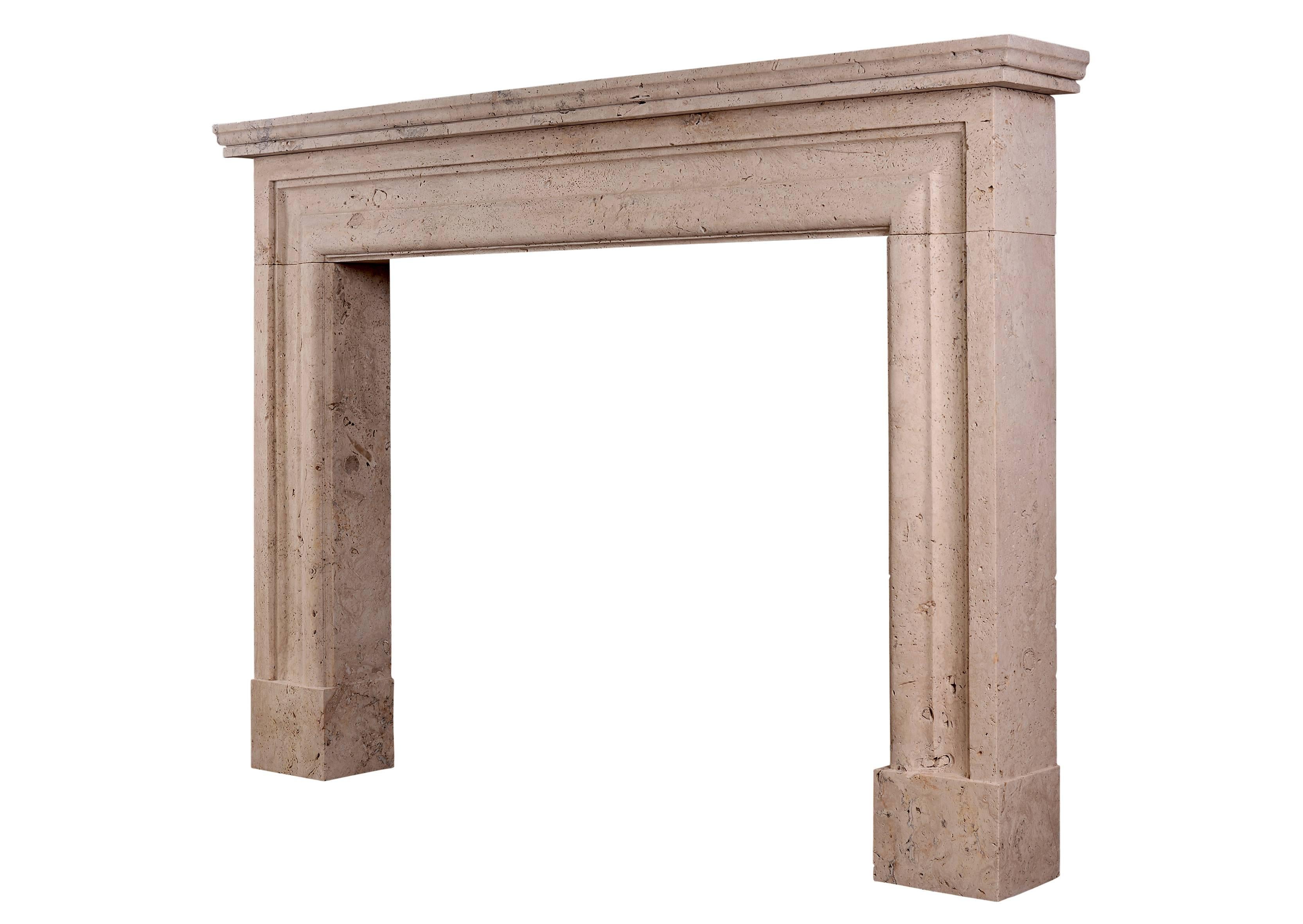 A large and imposing English molded bolection fireplace in white travertine stone. Modeled on a chimneypiece originally housed in the officer's mess at Chelsea Barracks, London. Can me made to any size in various materials.

Measures: 
Shelf