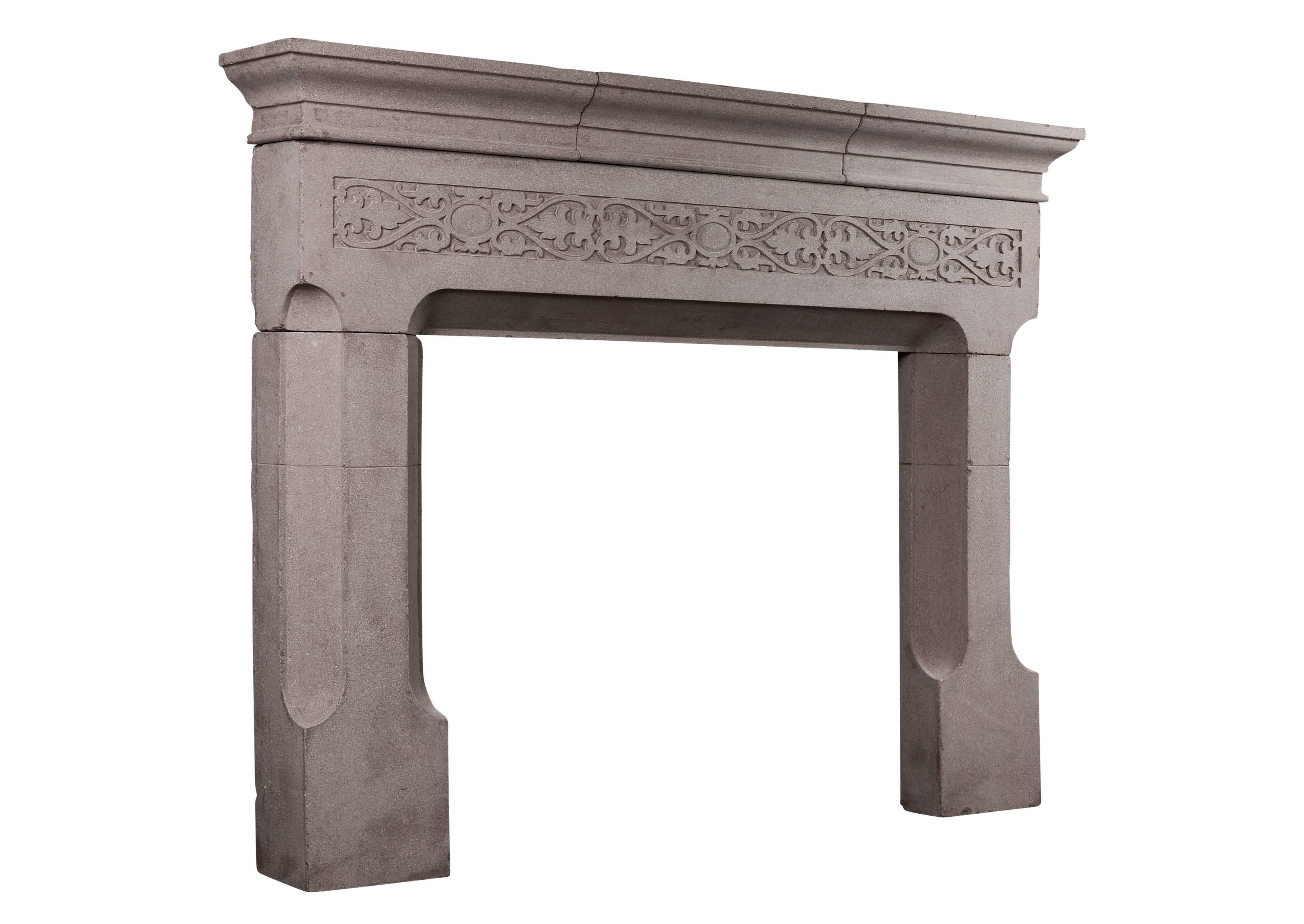 A finely cast stone fireplace in the Gothic style. The shaped legs surmounted by decorative frieze embellished with foliage and plain paterae throughout. Moulded shelf above. English, circa 1900.

Measurements: 
Shelf width: 1475 mm / 58 1/8