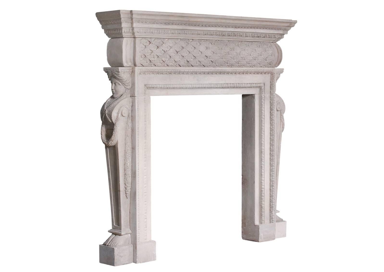 A 19th century English stone, Georgian style fireplace. The barrel frieze with carved laurel leaves and berries, supported by side facing caryatids with flowing garlands. The moulded jambs with acanthus mouldings, and the shelf with leaf and egg and