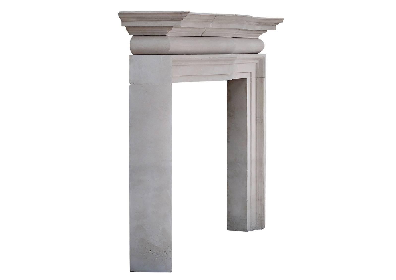 A large and imposing English Portland stone fireplace. The shaped barrel frieze surmounted by shaped, moulded shelf above. The heavy jambs with angled out grounds, circa 1900, quite possibly by Edwin Lutyens. A very impressive piece, which would