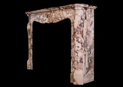 A French Louis XV style fireplace mantel in Brèche de Bénou marble
