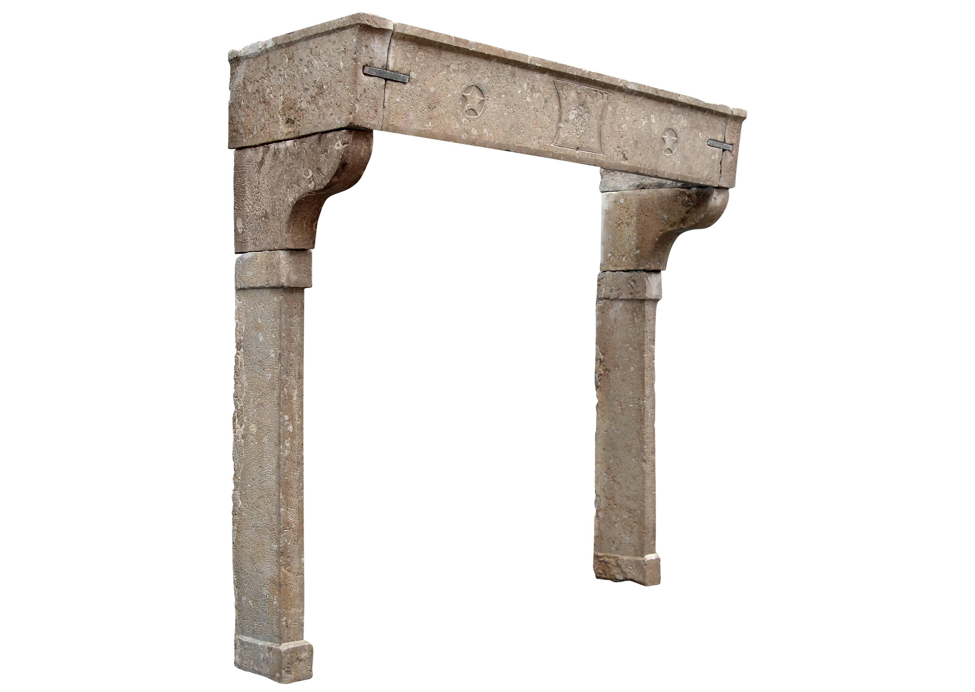 An 18th century French Louis XVI limestone fireplace, with carved centre motif dated 1777, and stars to frieze, plain jambs surmounted by shaped brackets. The frieze with polished metal connecting cramps (not shown in photograph).

Shelf Width:	1960