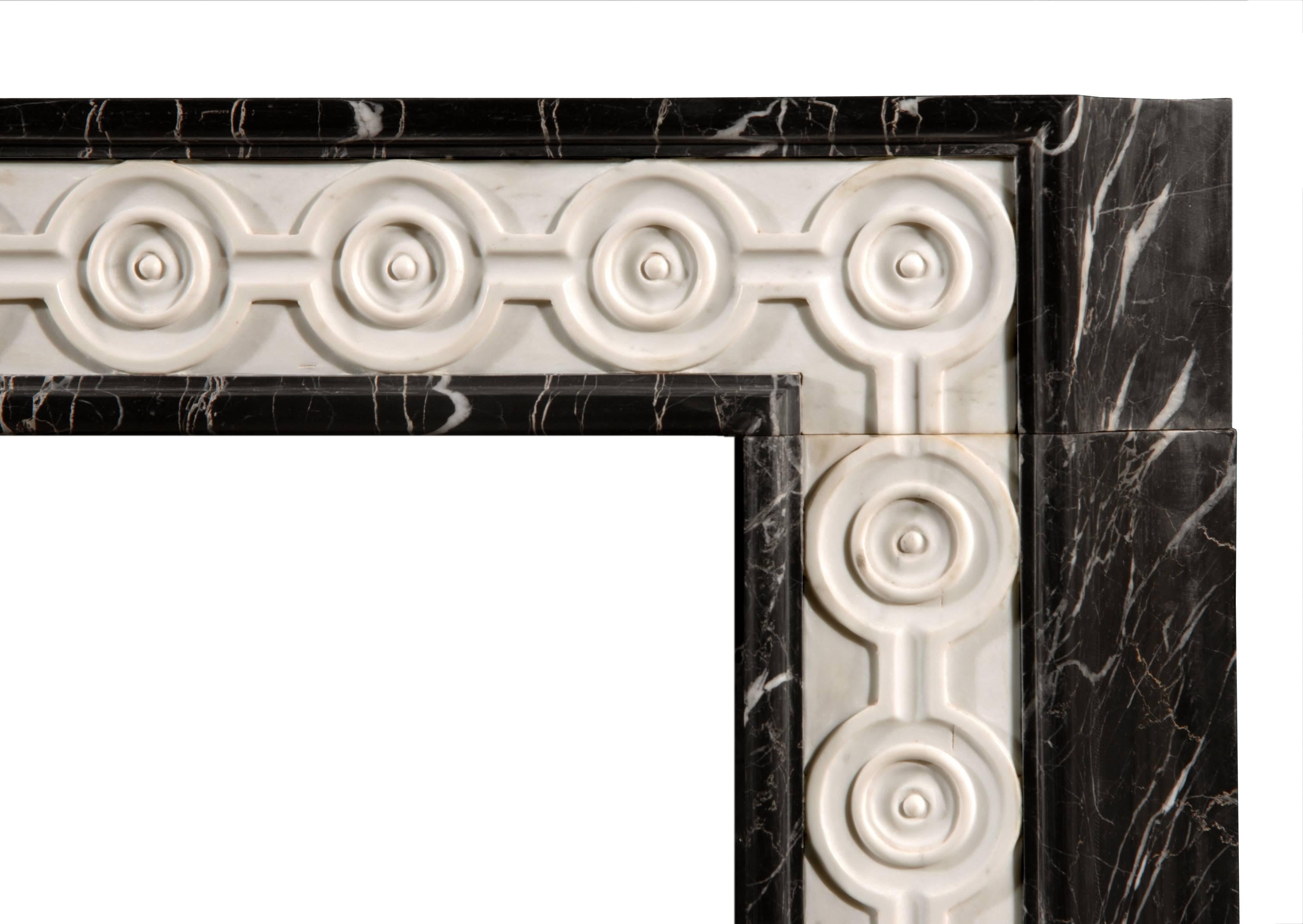 An English black and white veined marble fireplace inlaid with carved statuary guilloche carving.

Shelf Width:	1360 mm      	53 1/2 in
Overall Height:	1130 mm      	44 1/2 in
Opening Height:	1015 mm      	40 in
Opening Width:	1015 mm      	40