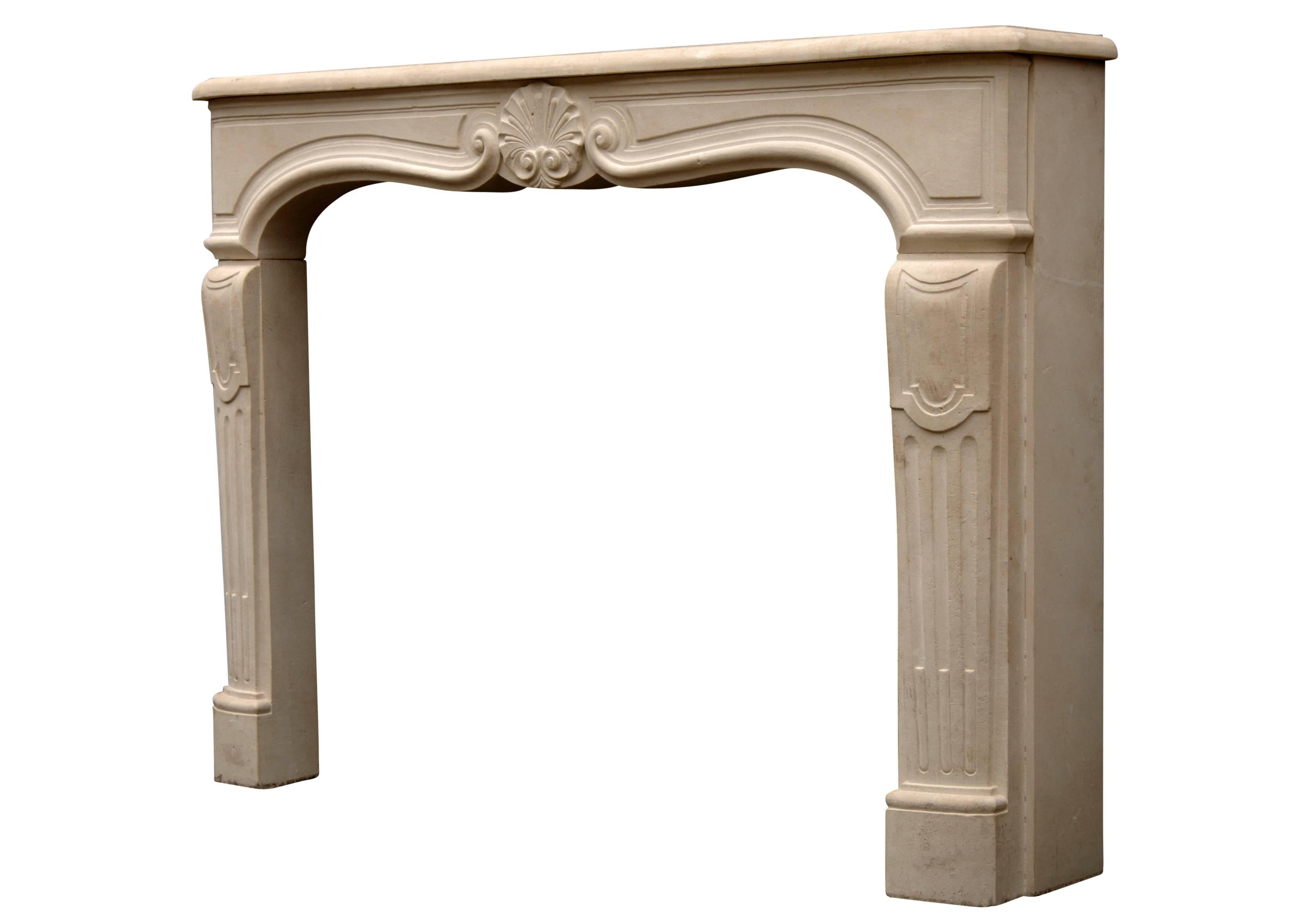 A 20th century Louis XV style limestone fireplace, with shell and scrolls to shaped frieze, shaped panelled and fluted jambs, surmounted by serpentine moulded shelf.

Shelf Width:	1600 mm      	63 in
Overall Height:	1155 mm      	45 1/2 in
Opening