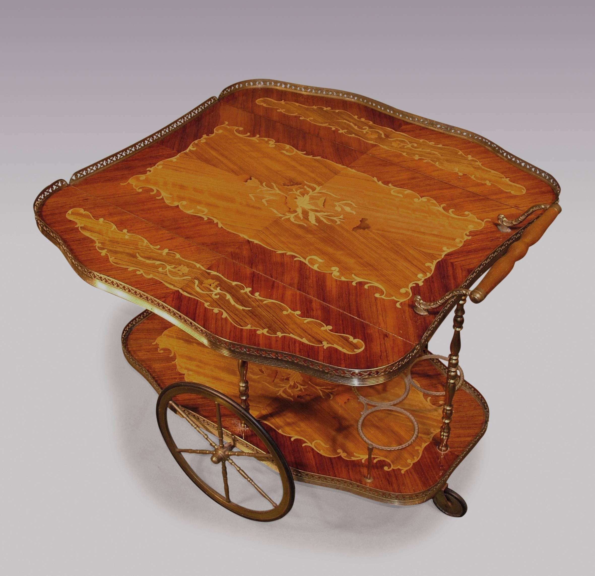 A unique Edwardian or later rosewood Drinks Trolley, having marquetry inlaid panels to the shaped galleried top, above similarly inlaid and galleried lower tier mounted with bottle holders, supported on brass spoke wheels.