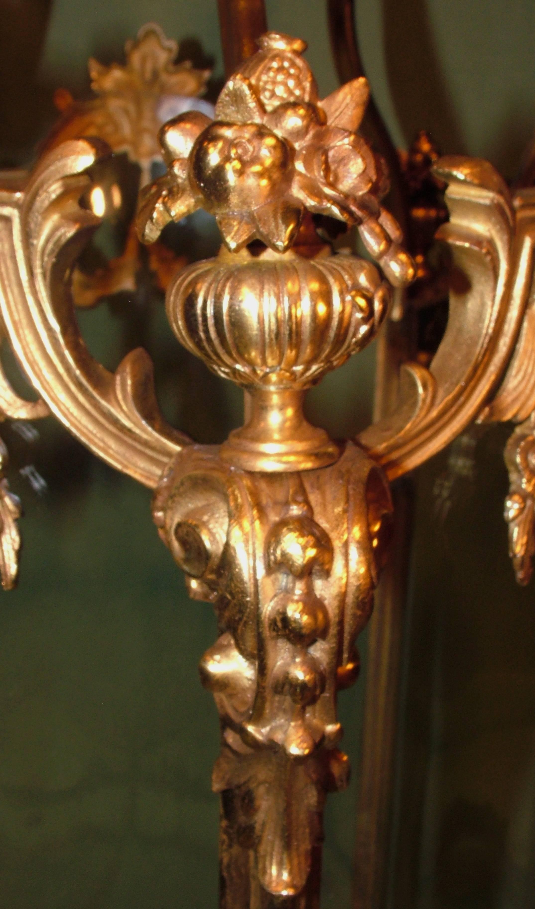 A large and impressive antique mid-19th century gilt brass five-sided Lantern, having C-scroll arms above serpentine panels decorated with acanthus scrolls, rose garlands and urns with fruit raised on scrolled brackets. The base similarly decorated