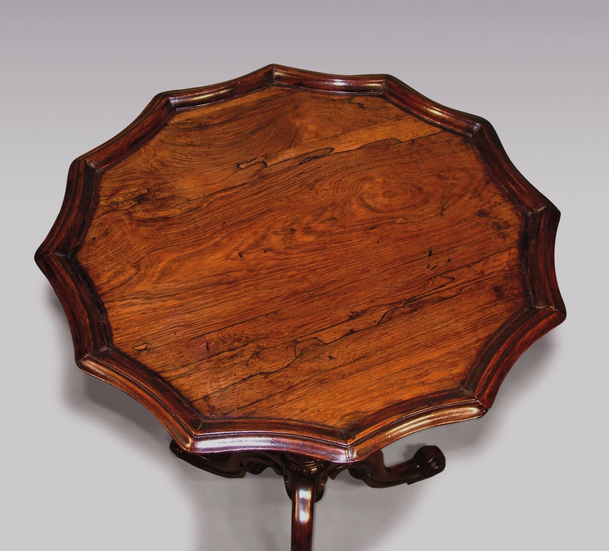 An attractive mid-19th century rosewood tripod table, having circular top with concave shaped edge, raised on reeded stem with vase carving, ending on tripod legs with scrolled feet.