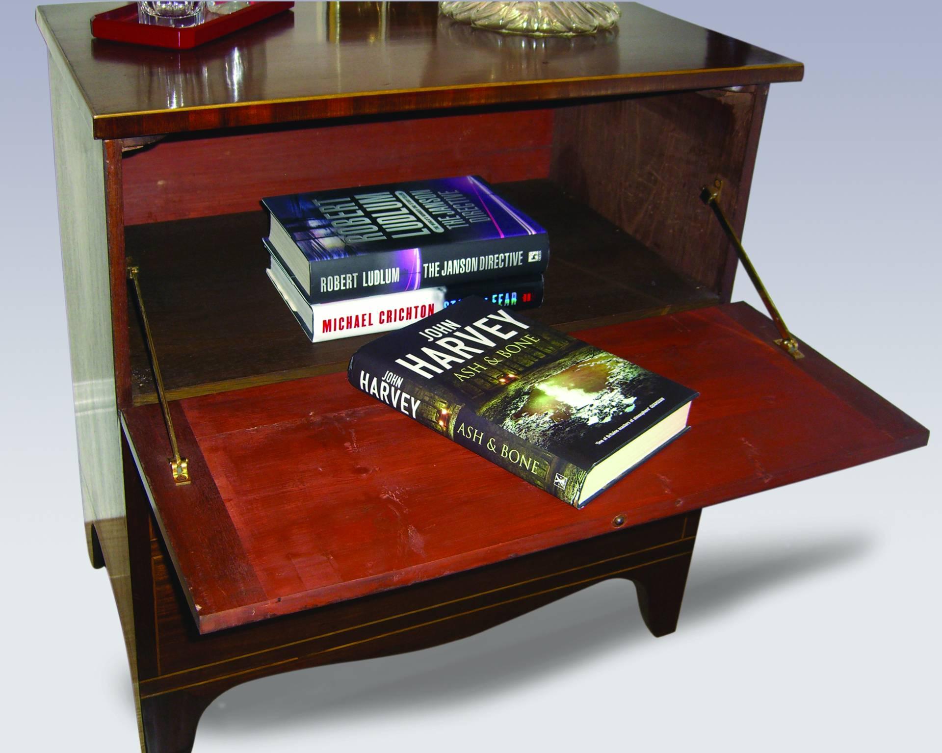 A near pair of George III figured mahogany commode chests, boxwood strung throughout, having converted commode drawers supported on splayed bracket feet with shaped aprons.