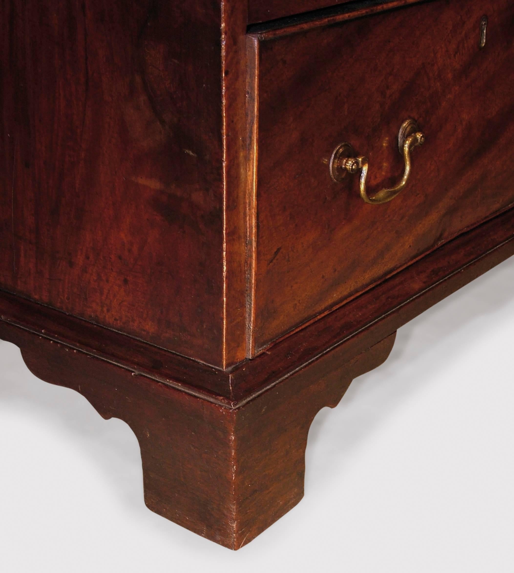 A mid-18th century figured mahogany chest of unusual proportions, having moulded edge top, above four short and three long cockbeaded drawers retaining original swan-neck handles and shaped bracket feet, circa 1770.