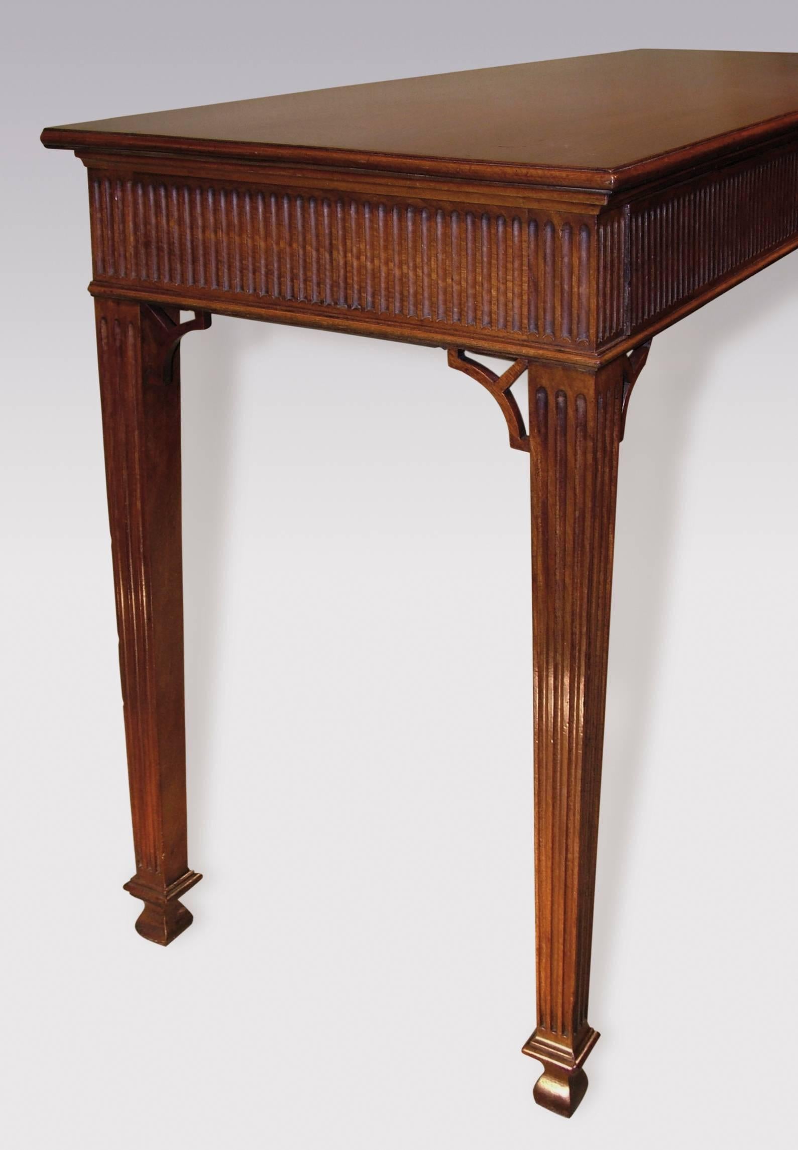 A mid-18th century Chippendale period figured mahogany Serving Table, having moulded edged rectangular top, above fluted frieze with concealed drawers, supported on fluted tapering legs with pierced corner brackets ending on “club” feet.