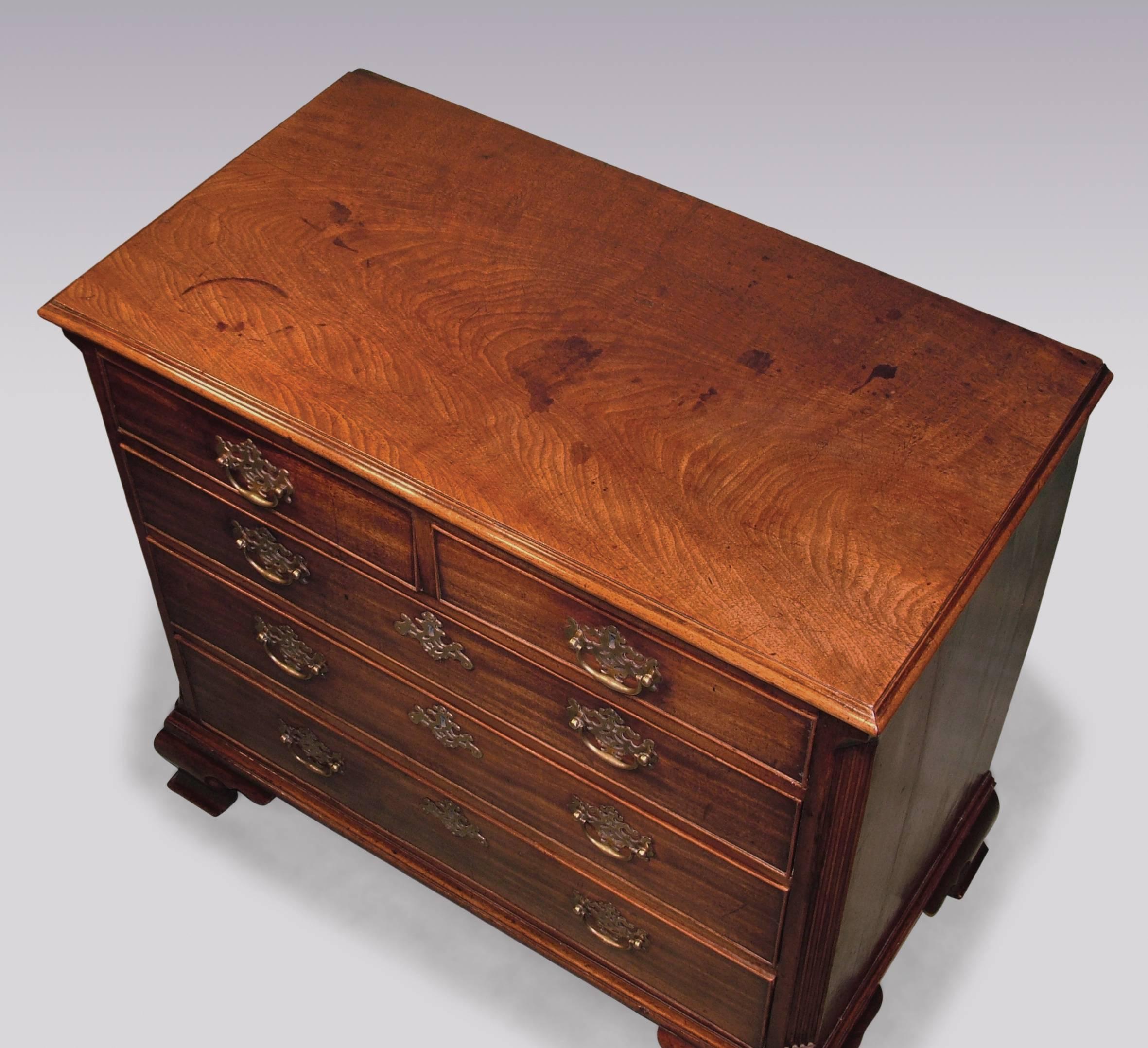 A mid-18th century George III period well-figured mahogany straight front chest, having moulded edge top above two short and three long cockbeaded drawers, retaining original handles, flanked by fluted canted corners, supported on ogee bracket feet.